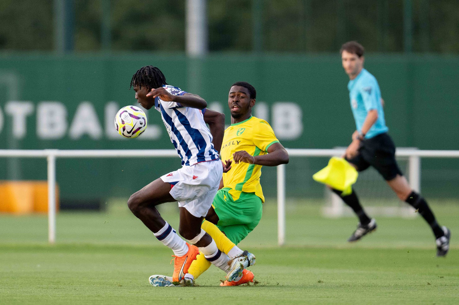 Muhamed Diomande fights for the ball with a Norwich PL2 player 