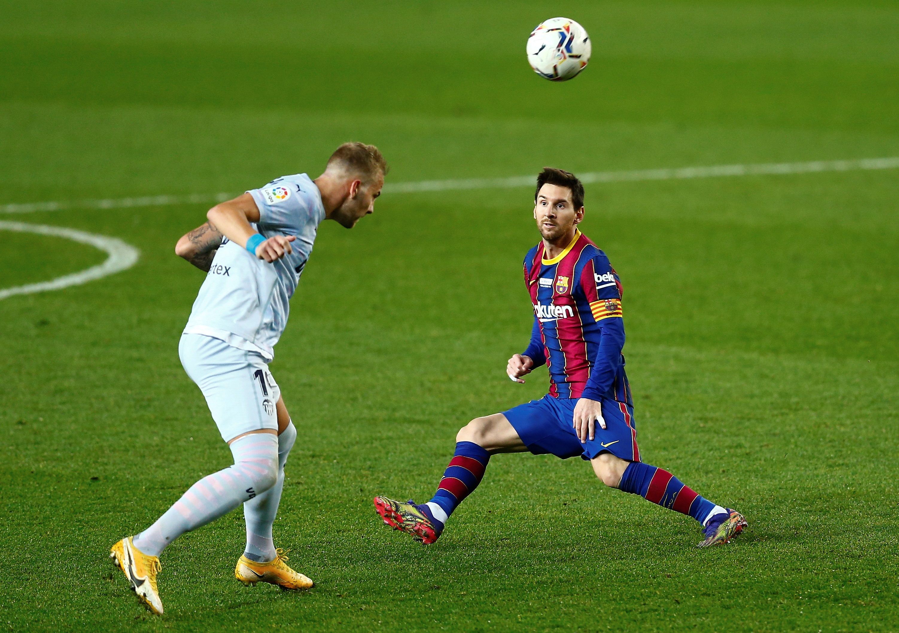 Uroš Račić in action for Valencia against Barcelona and Lionel Messi in December 2020