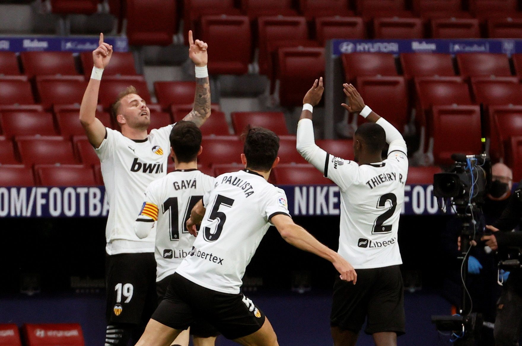 Uroš Račić celebrates scoring for Valencia at Atletico Madrid in 2021 with team-mates 