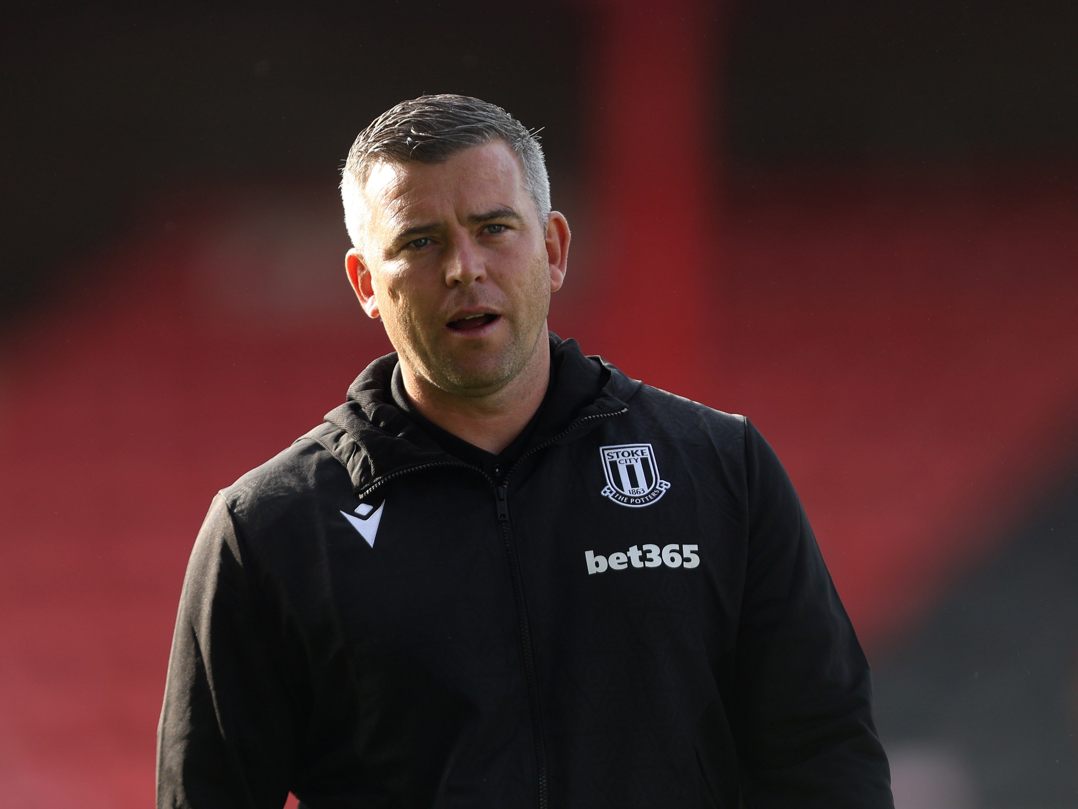 Stoke City's manager Steven Schumacher in a black Stoke tracksuit 