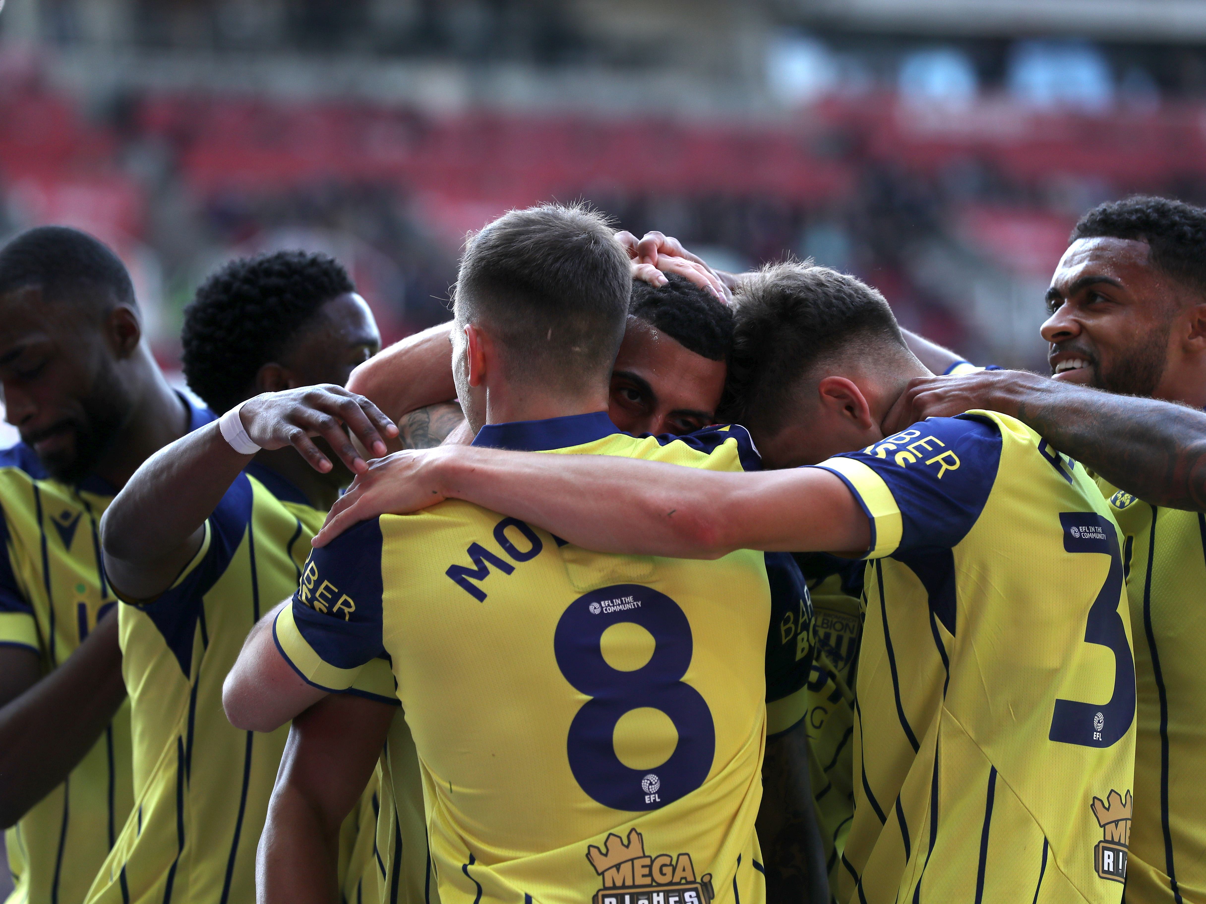 An image of the Albion team celebrating with Karlan Grant after his Stoke goal