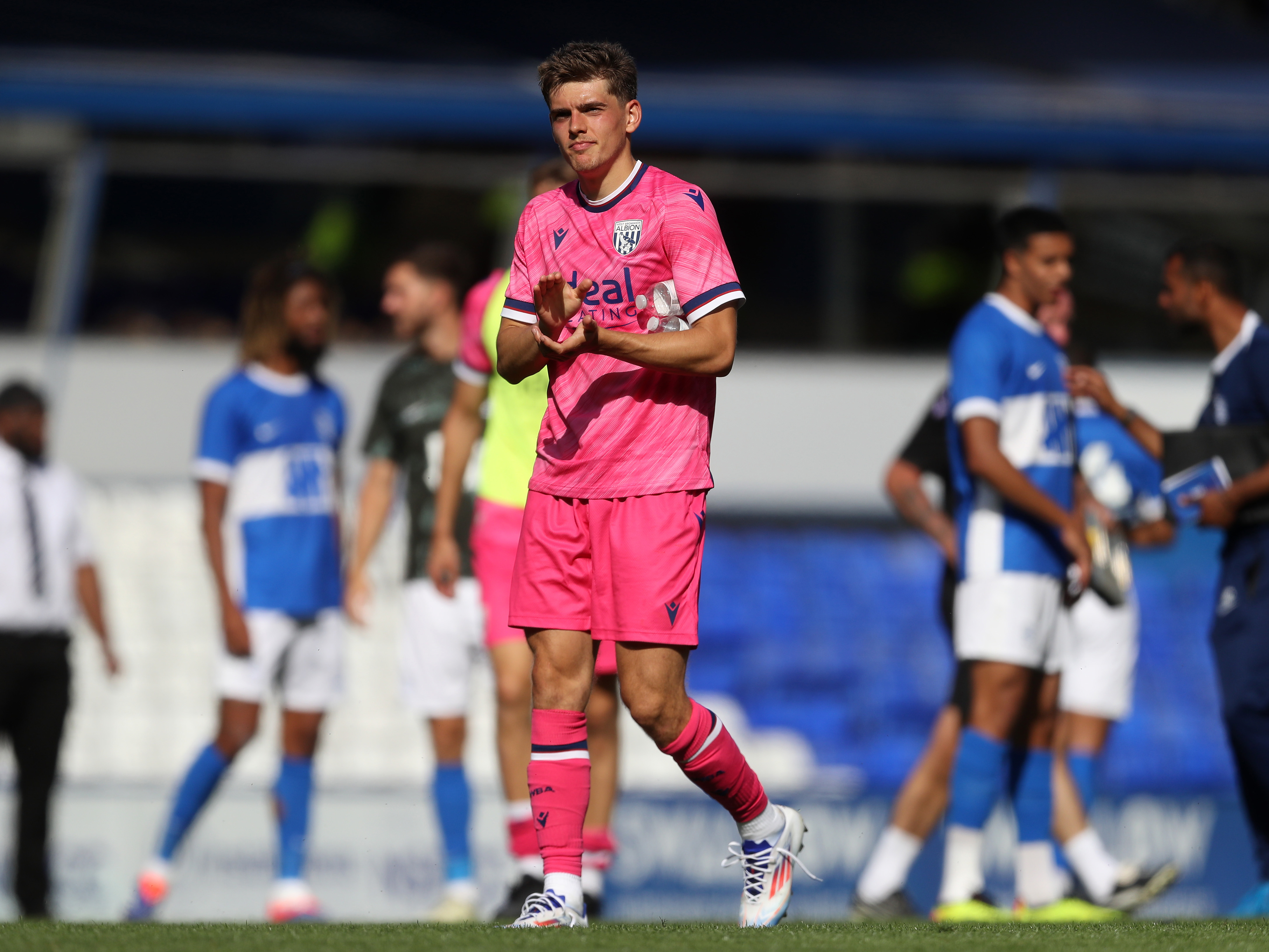 A photo of Tom Fellows in the pink 2024/25 away kit clapping the fans after a friendly with Birmingham