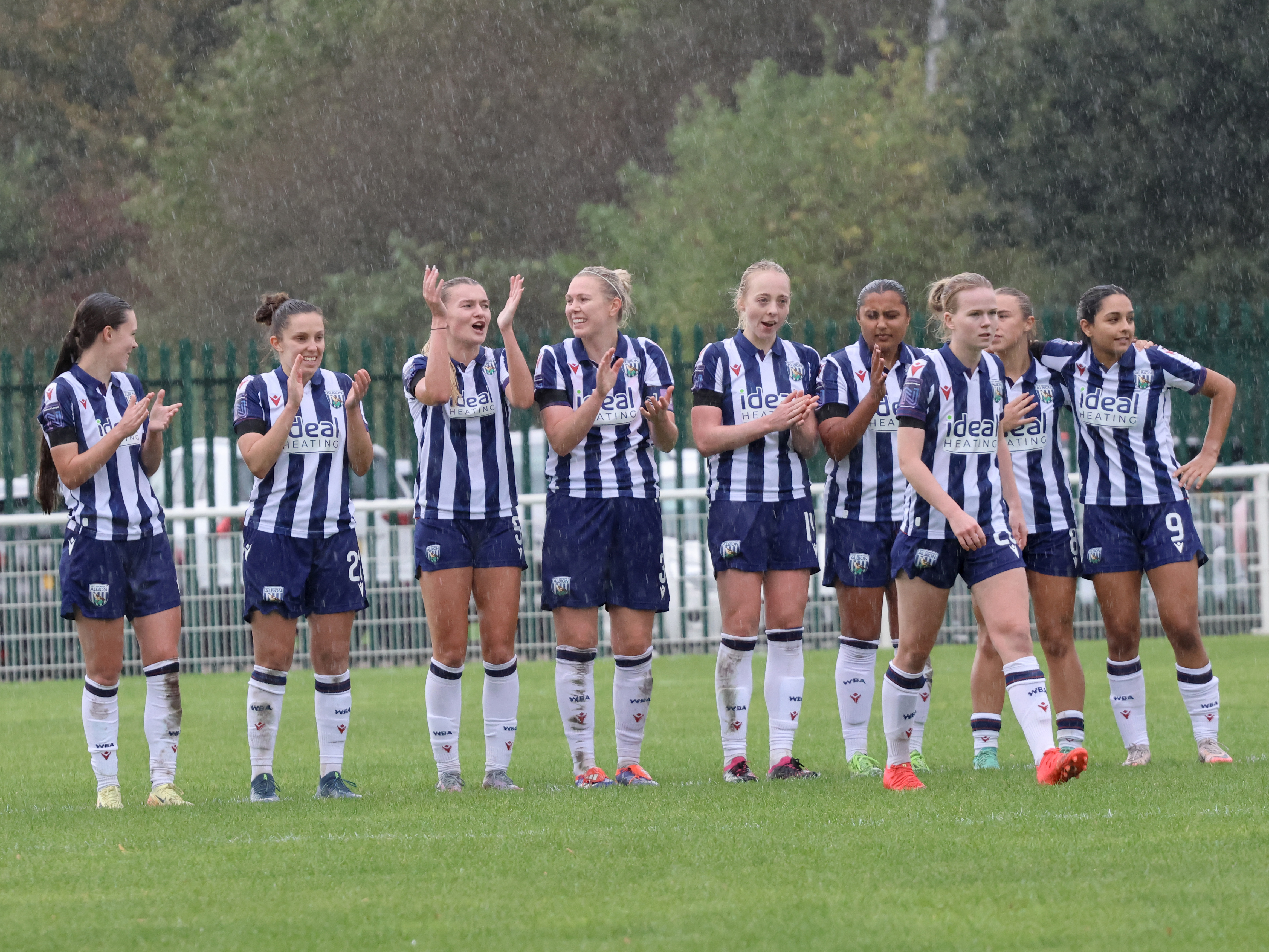 Albion Women celebrate a successful penalty during the game against Northampton Town while wearing home kits 