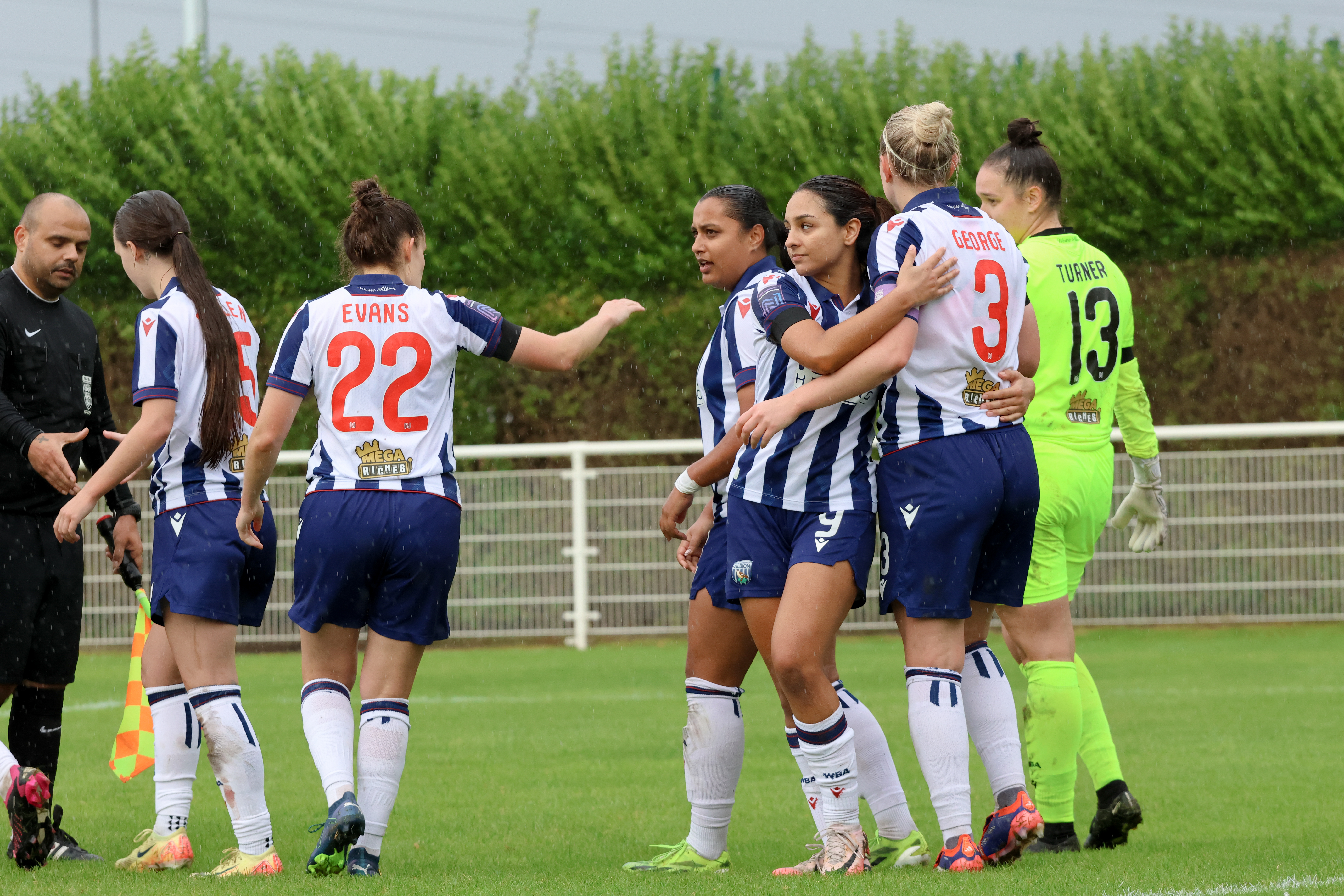 Simran Jhamat and Albion team-mates celebrate after beating Northampton Town while wearing the home kit