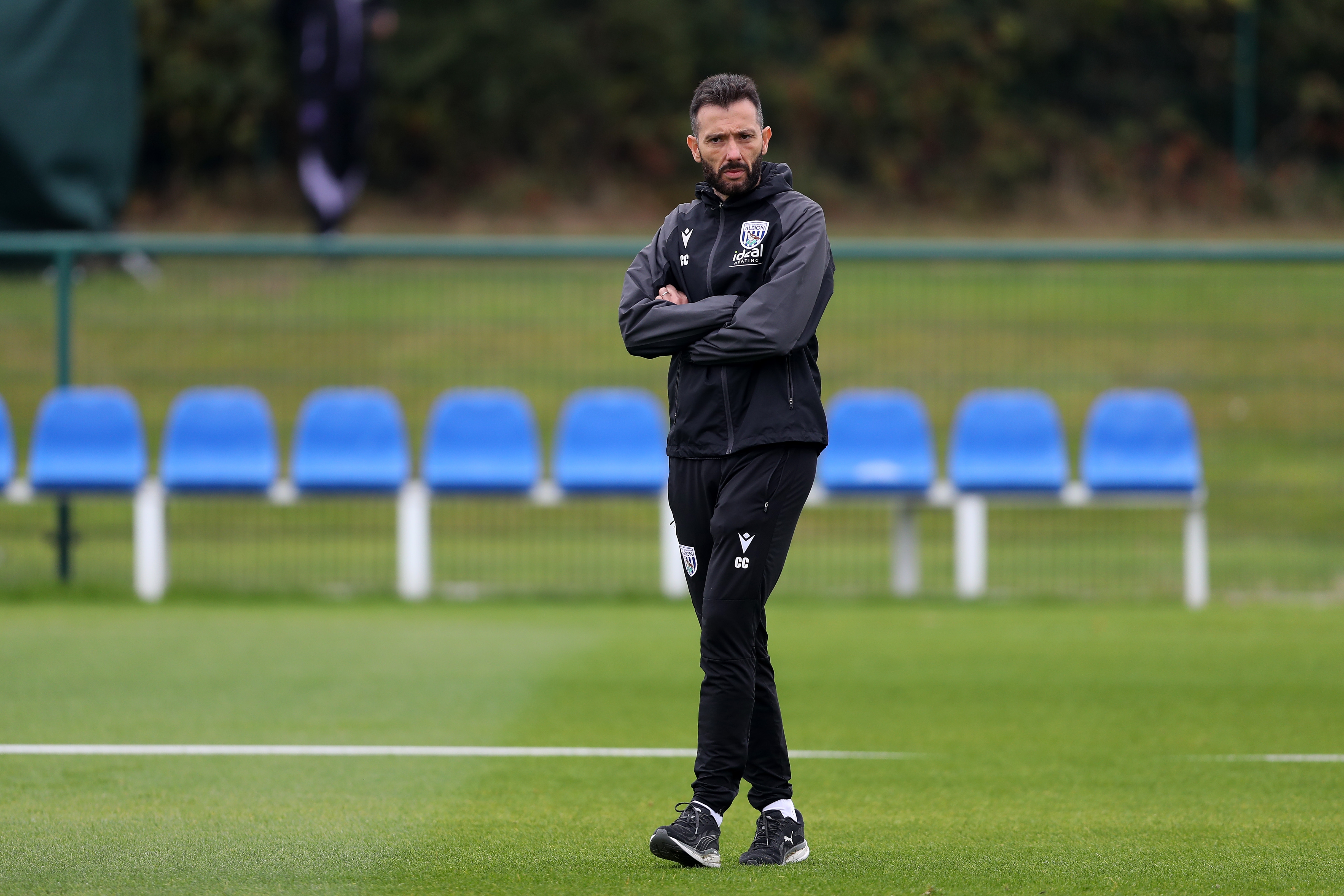 Carlos Corberán watching training with his arms folded 