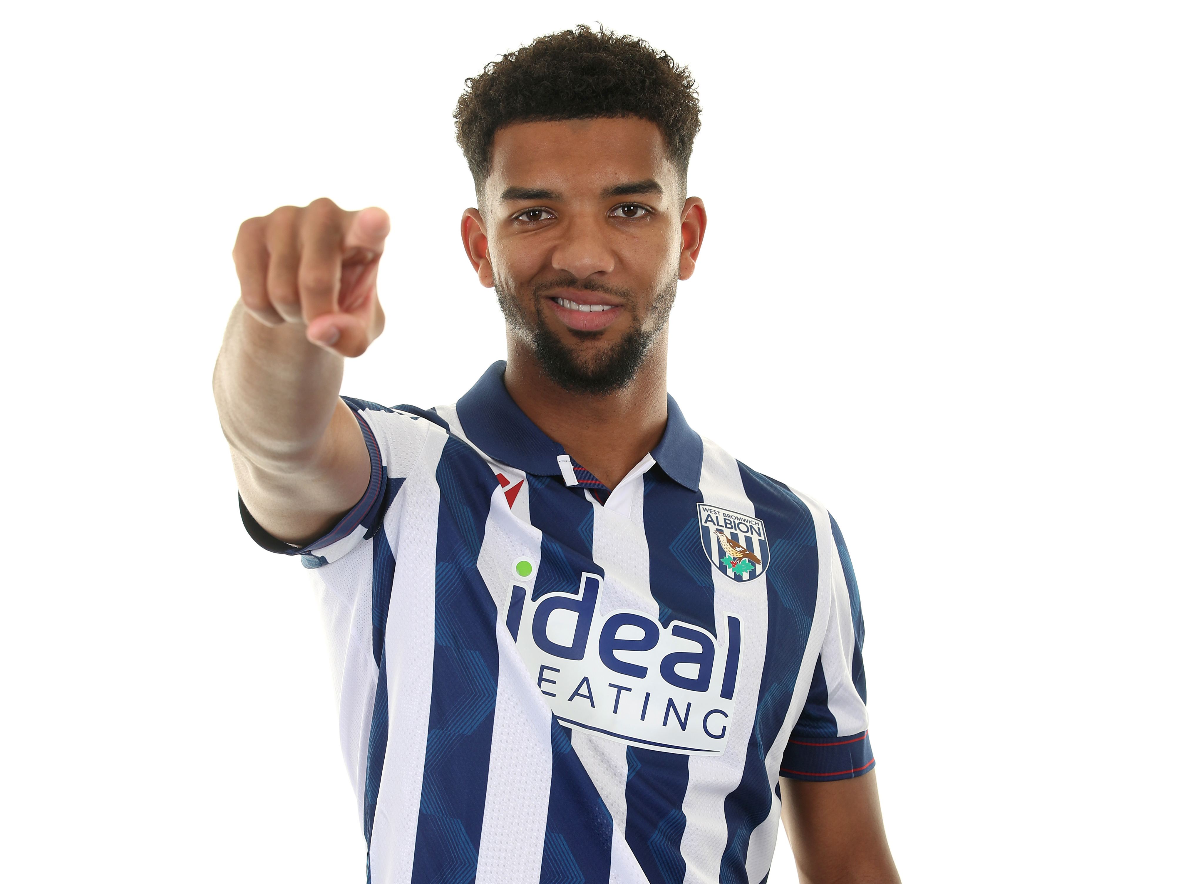 Mason Holgate smiling and pointing at the camera in a home shirt 