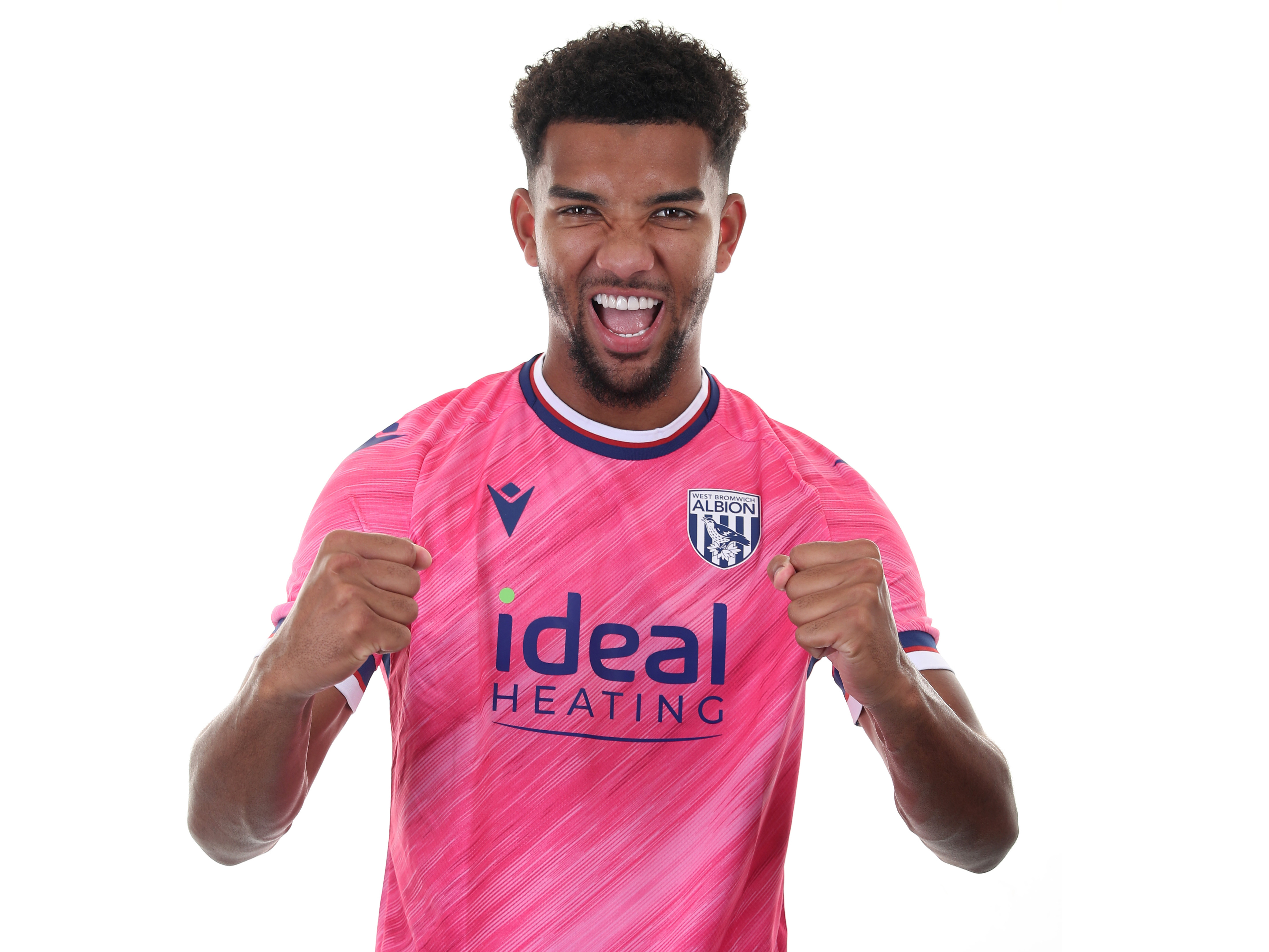 Mason Holgate celebrating at the camera whilw wearing a pink away shirt 