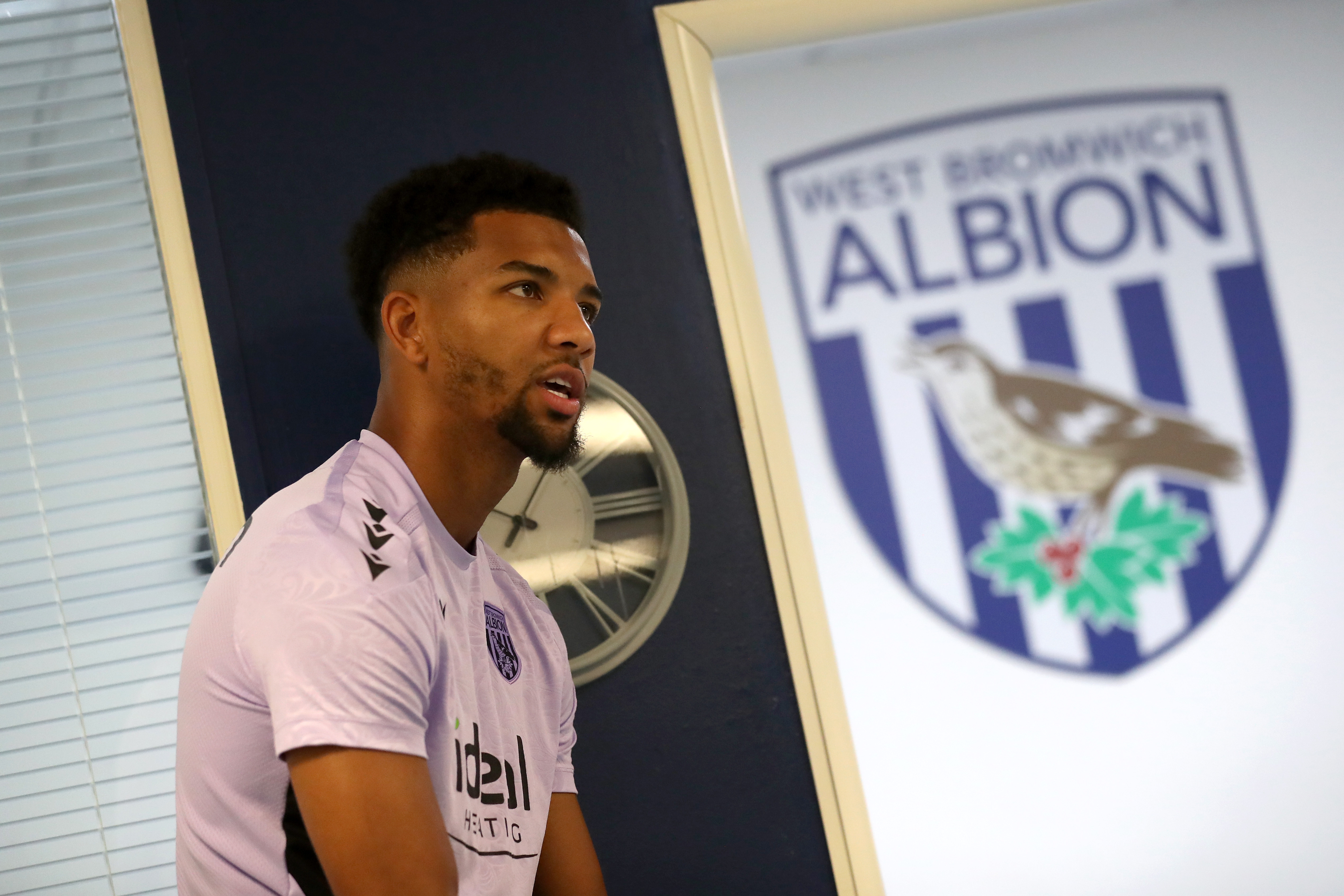 Mason Holgate next to a big WBA badge 