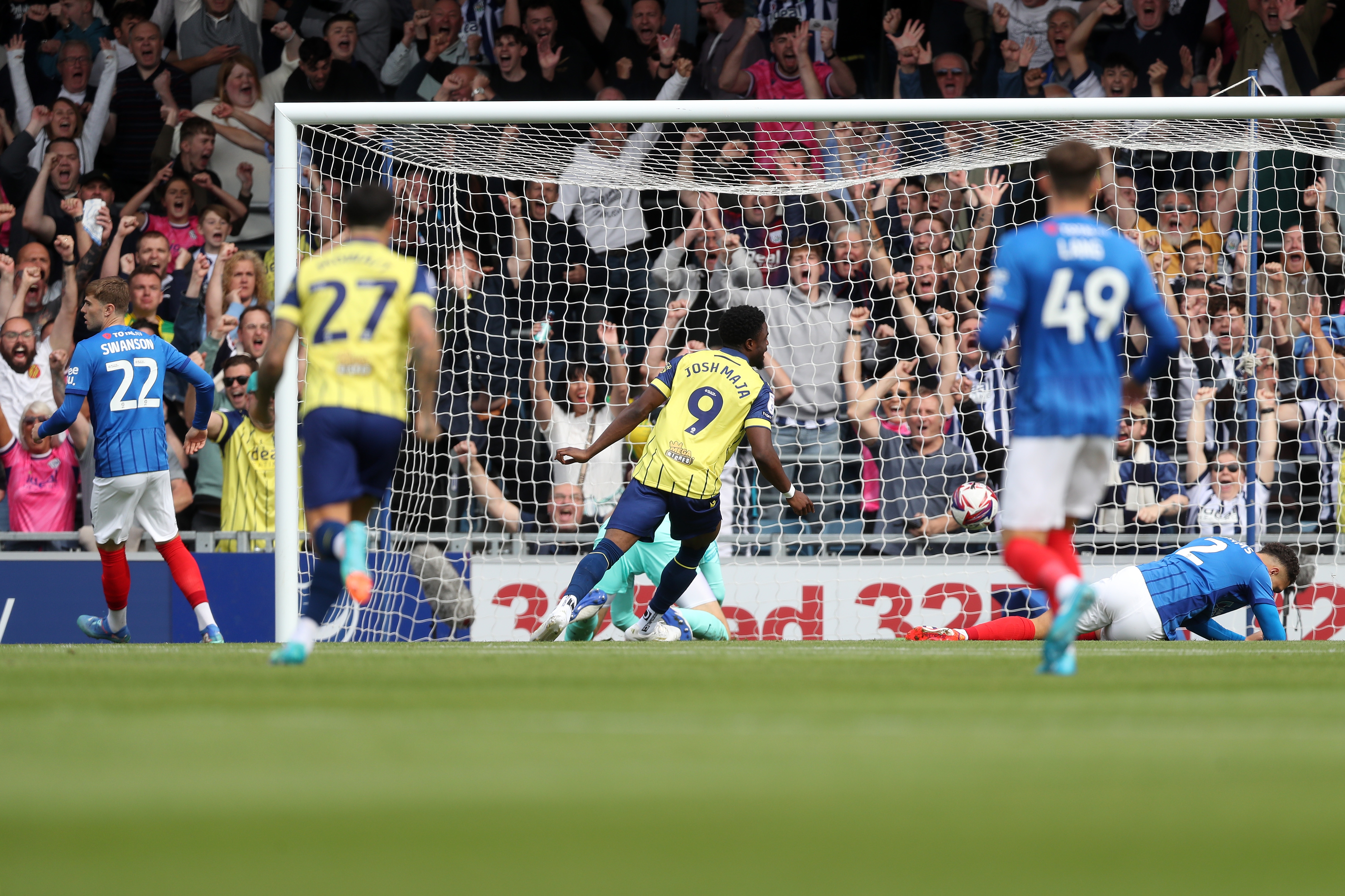 Albion in action against Portsmouth at Fratton Park, in yellow and blue away colours.