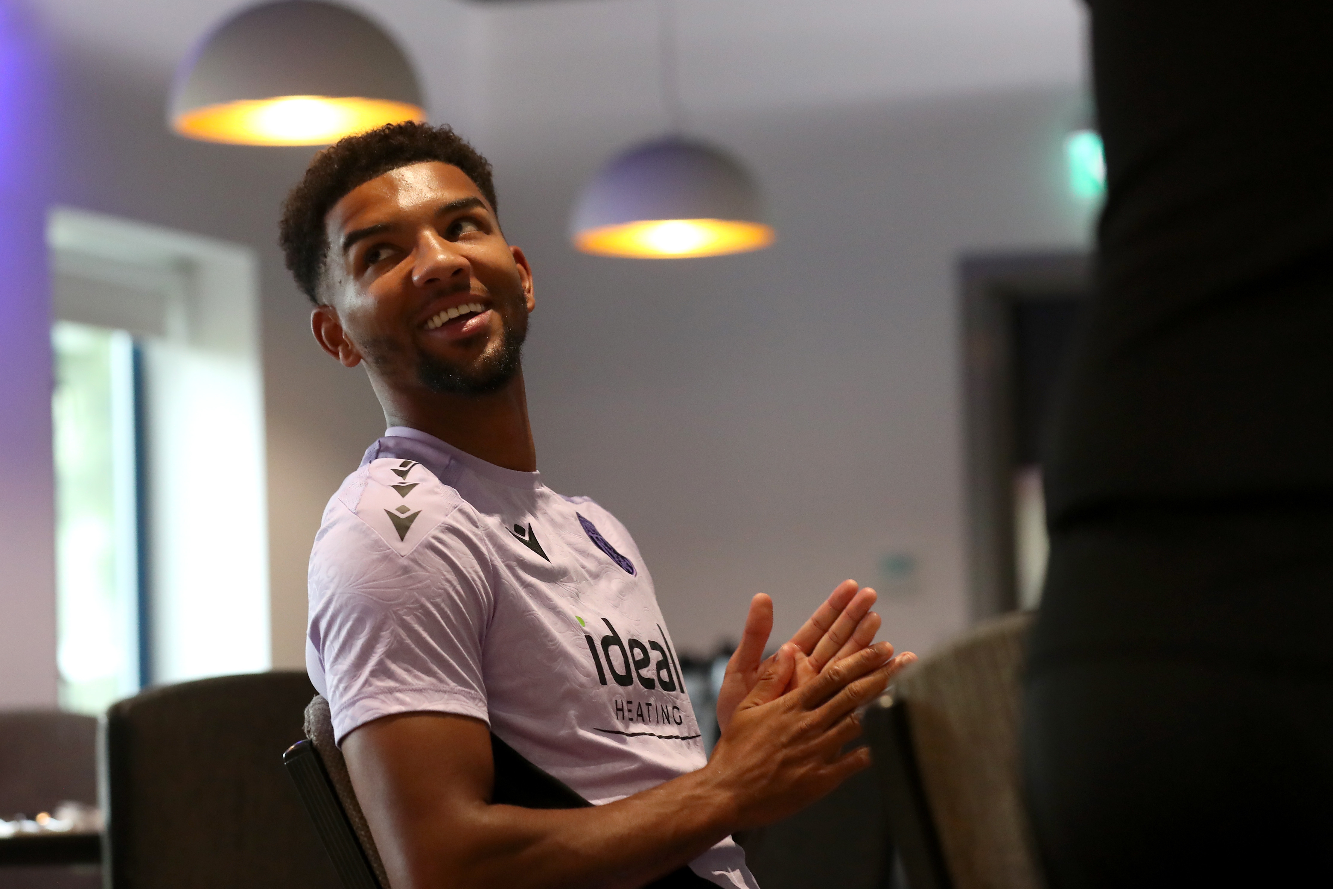 Mason Holgate smiling looking over his shoulder in the canteen