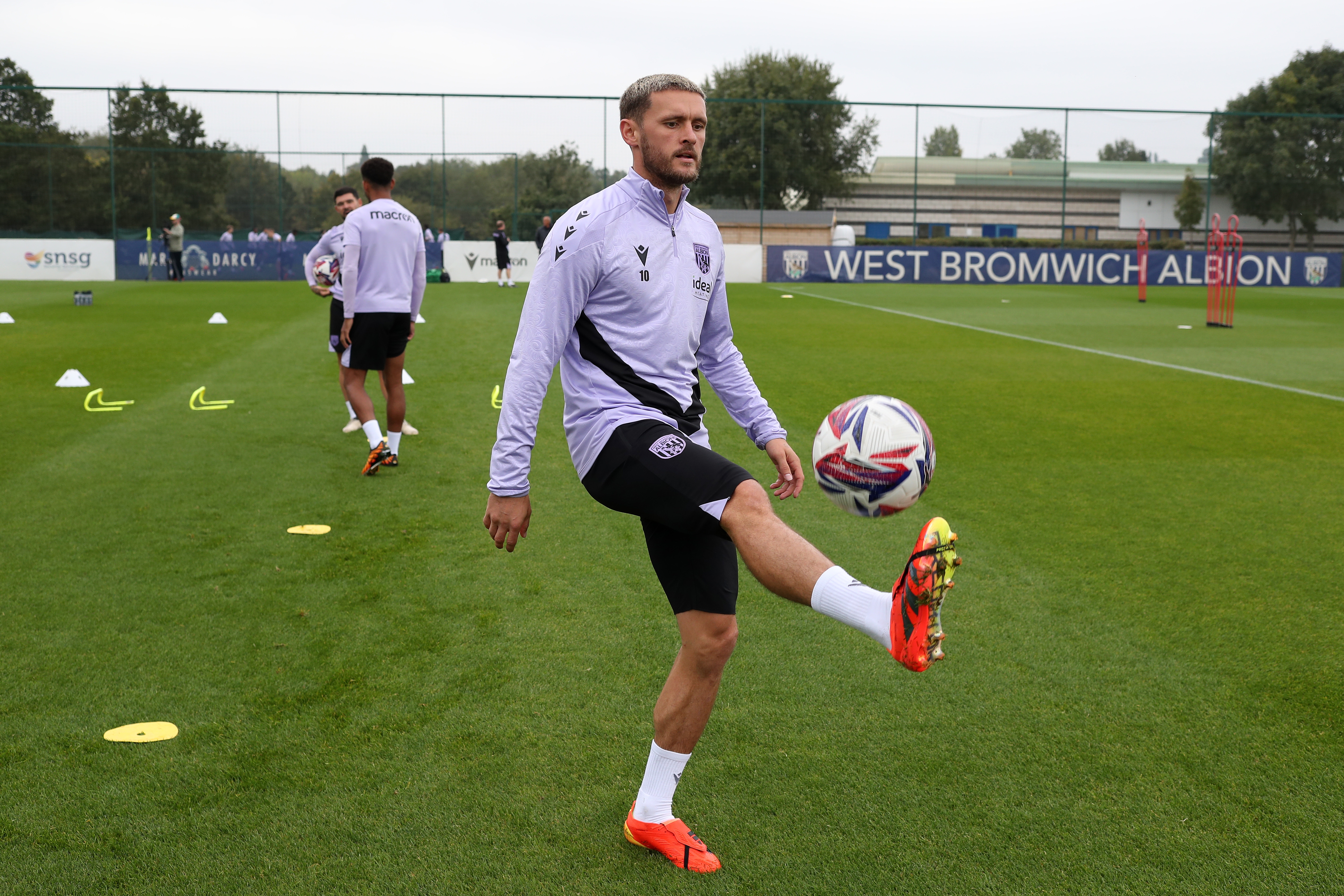 John Swift juggling a ball during a training session 