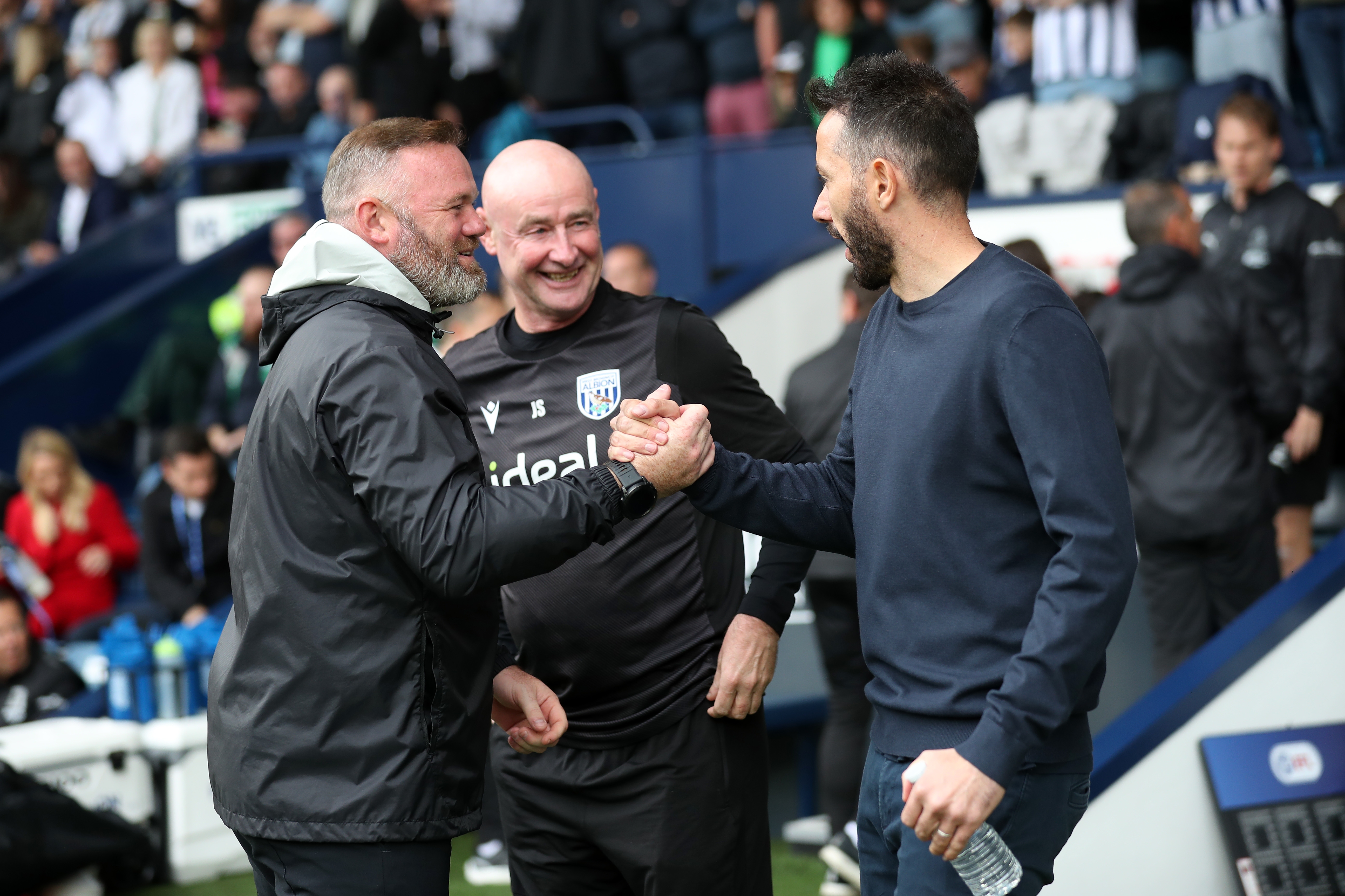 Wayne Rooney and Carlos Corberán shake hands at the side of the pitch at The Hawthorns 