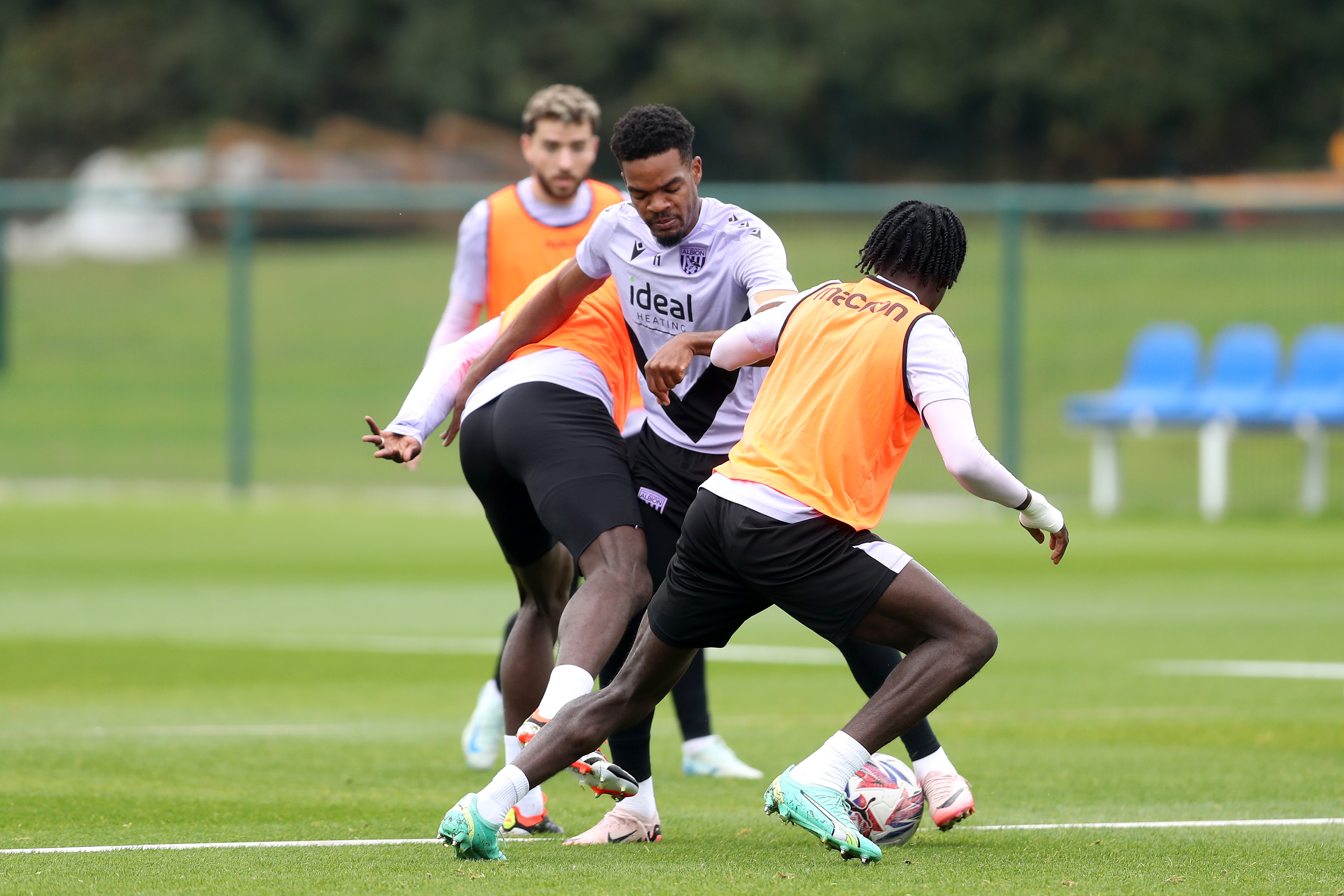 Grady Diangana trying to escape the challenge of two players during a training session 