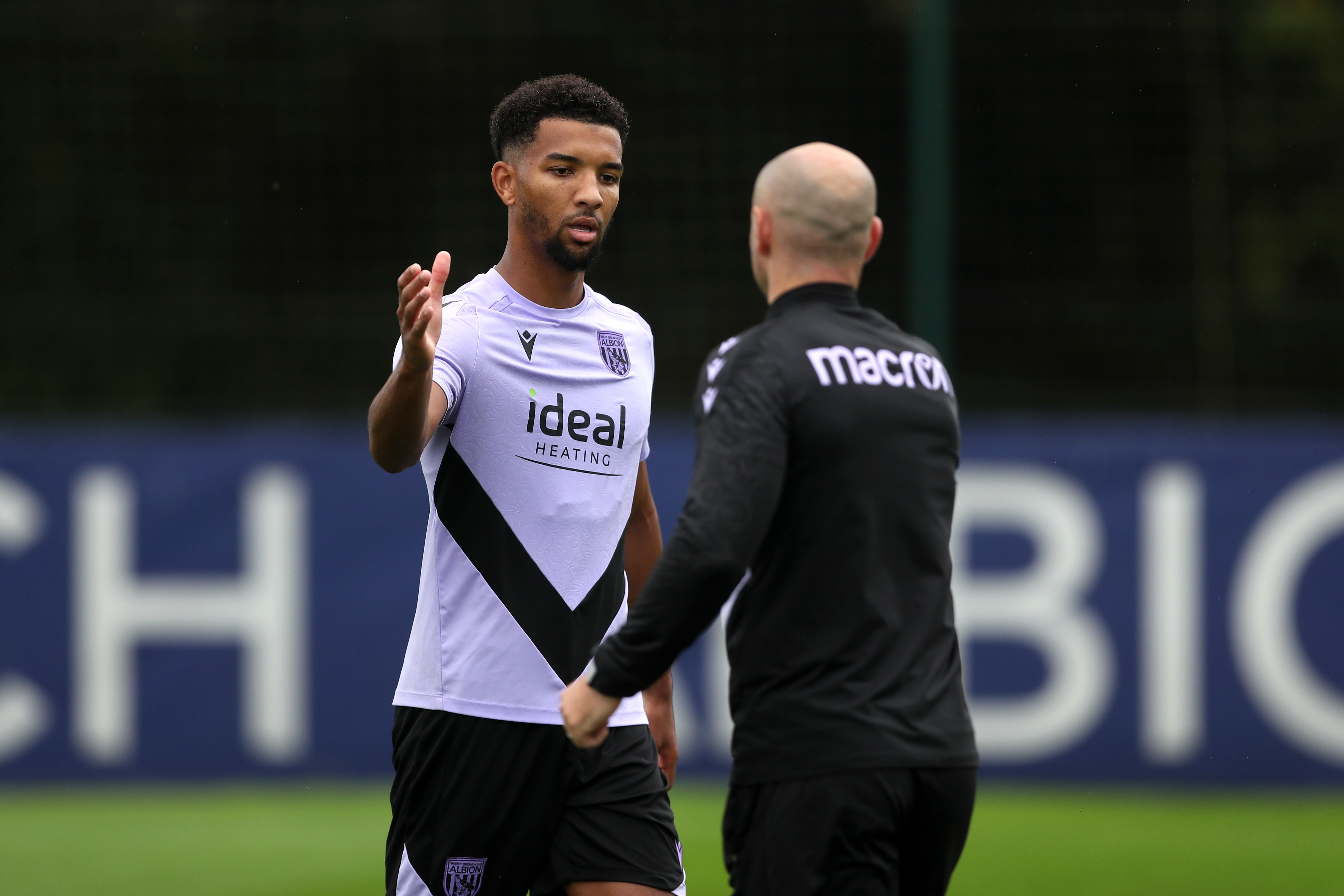 Mason Holgate high fives a member of staff out on the training pitch