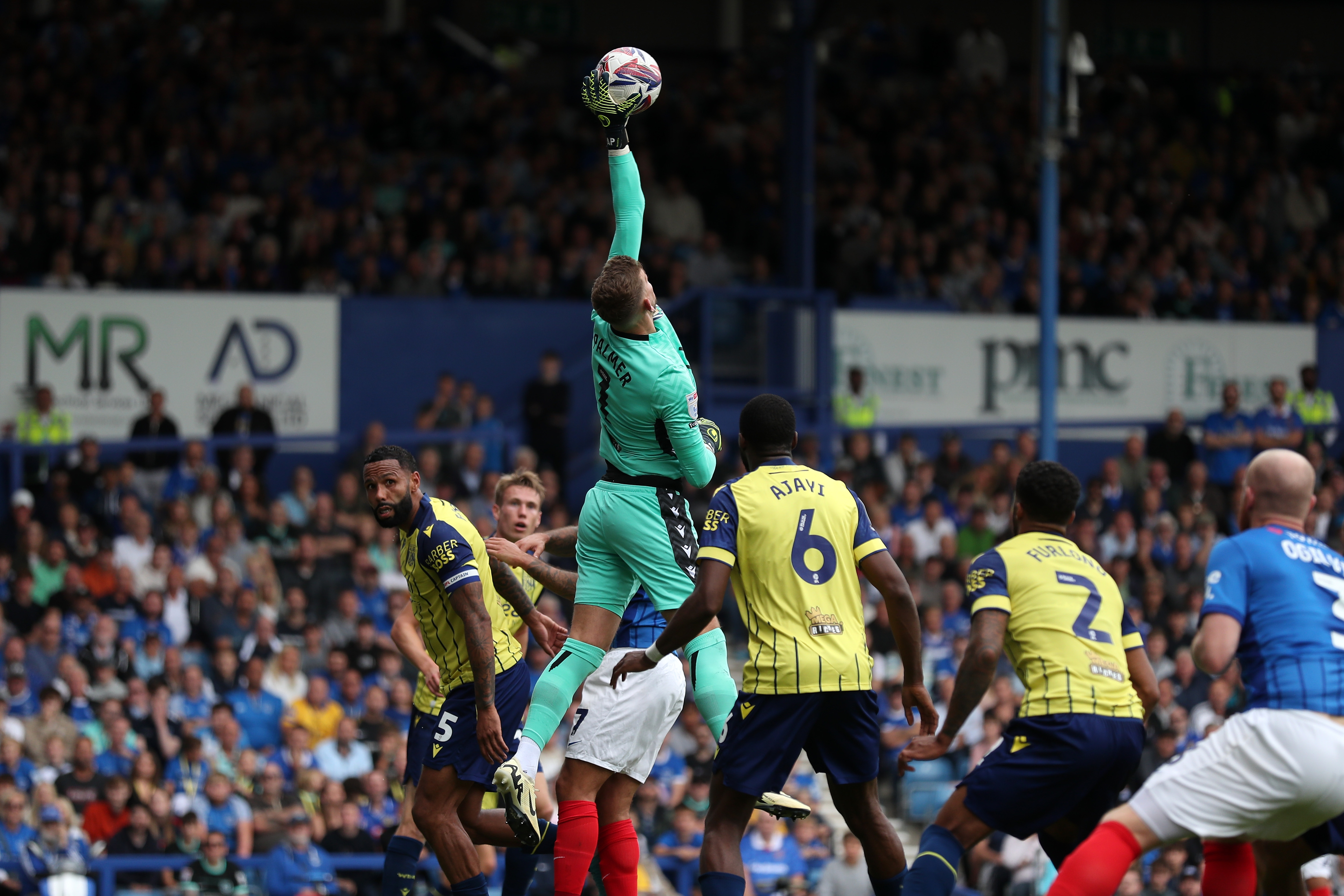 Albion in action against Portsmouth at Fratton Park, in yellow and blue away colours.