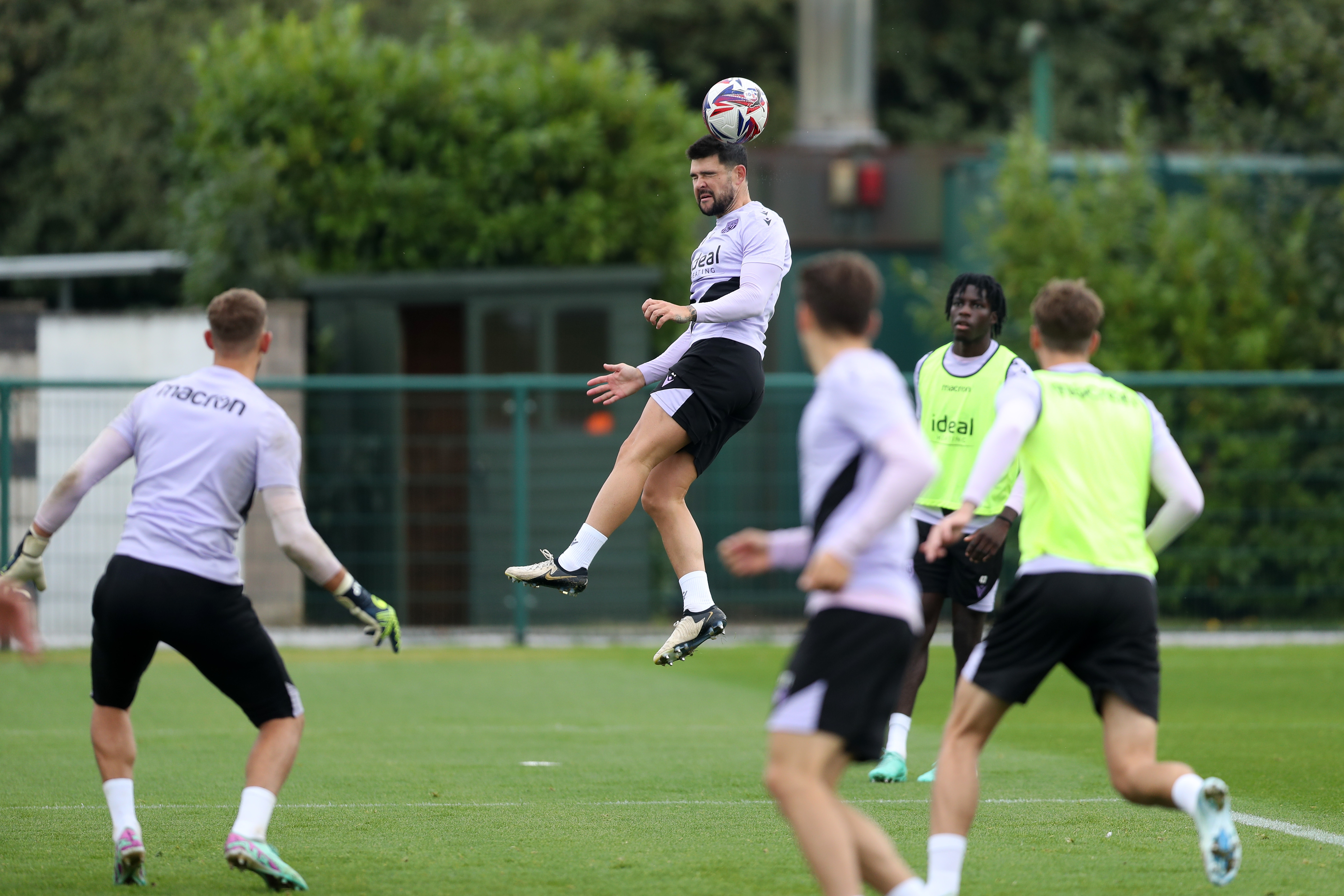 Alex Mowatt heading the ball during a training session 