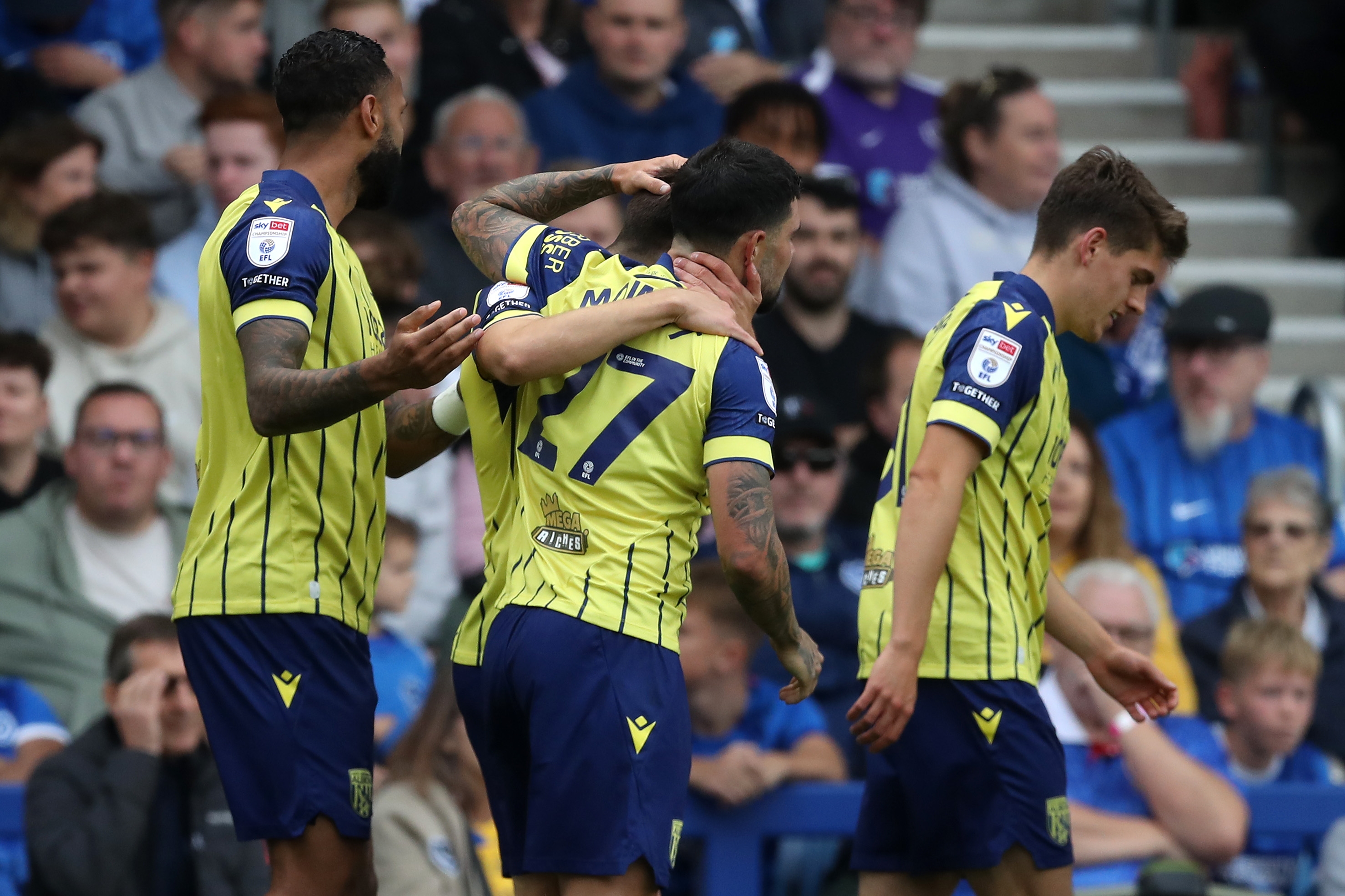 Albion in action against Portsmouth at Fratton Park, in yellow and blue away colours.