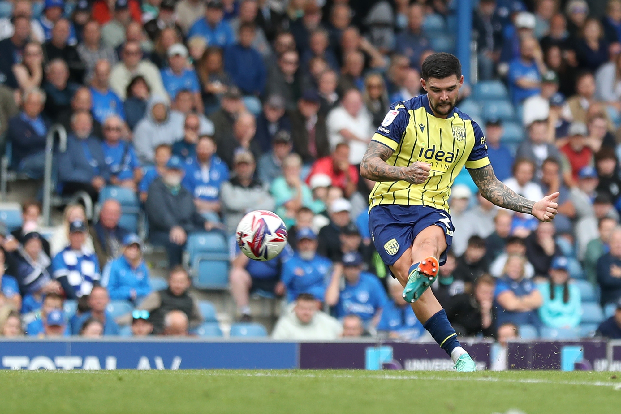 Albion in action against Portsmouth at Fratton Park, in yellow and blue away colours.