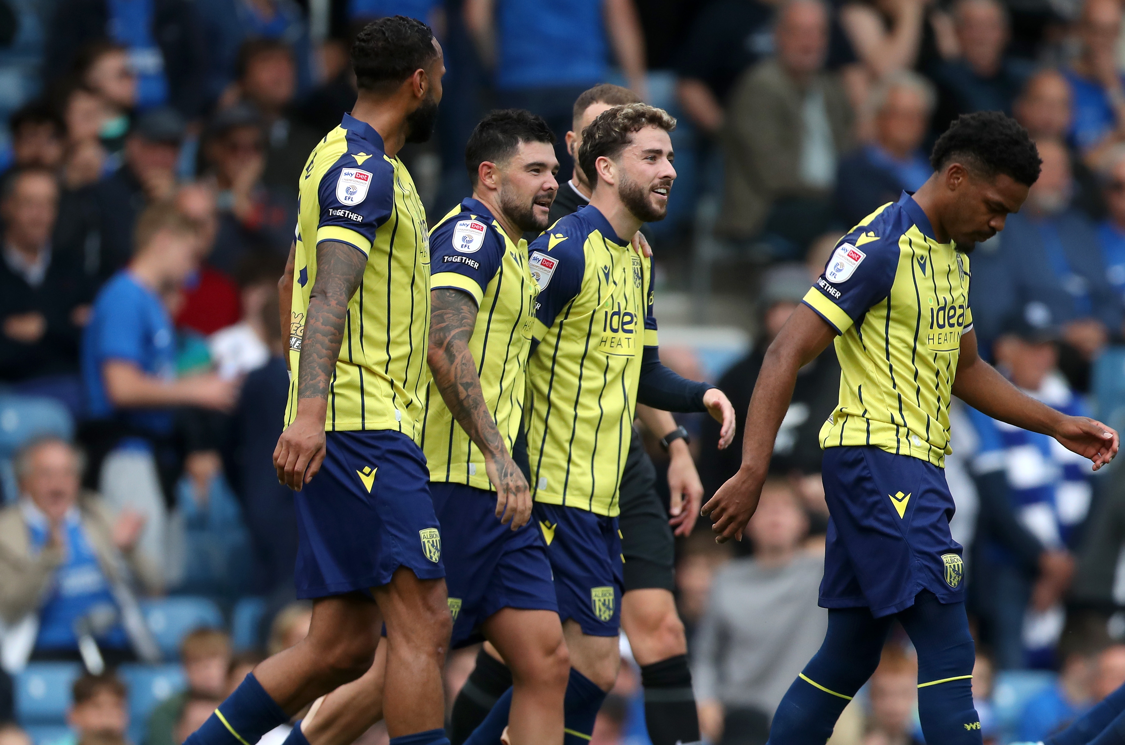 Albion in action against Portsmouth at Fratton Park, in yellow and blue away colours.