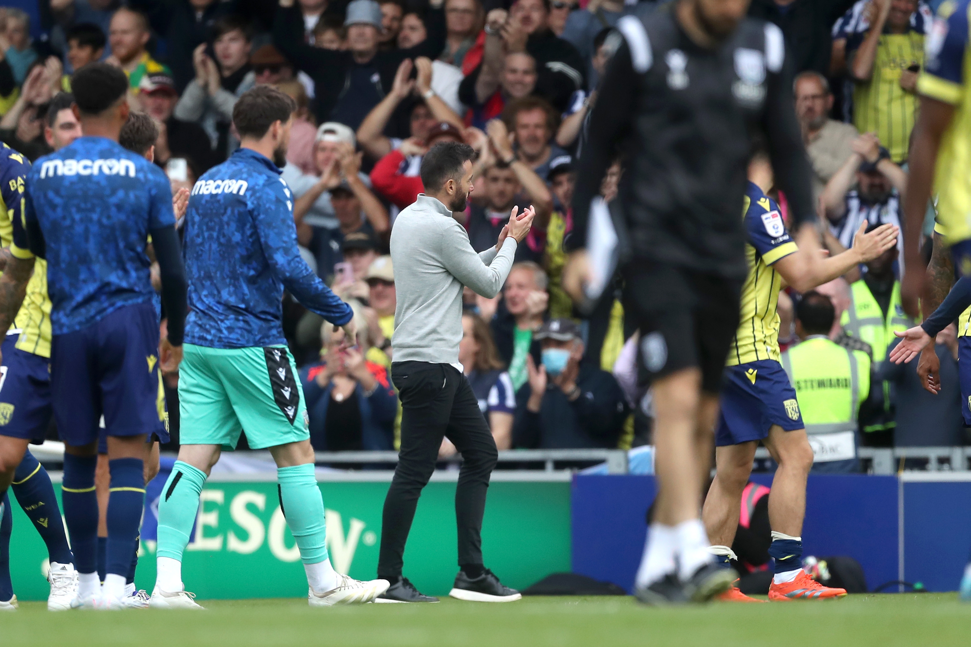 Albion in action against Portsmouth at Fratton Park, in yellow and blue away colours.