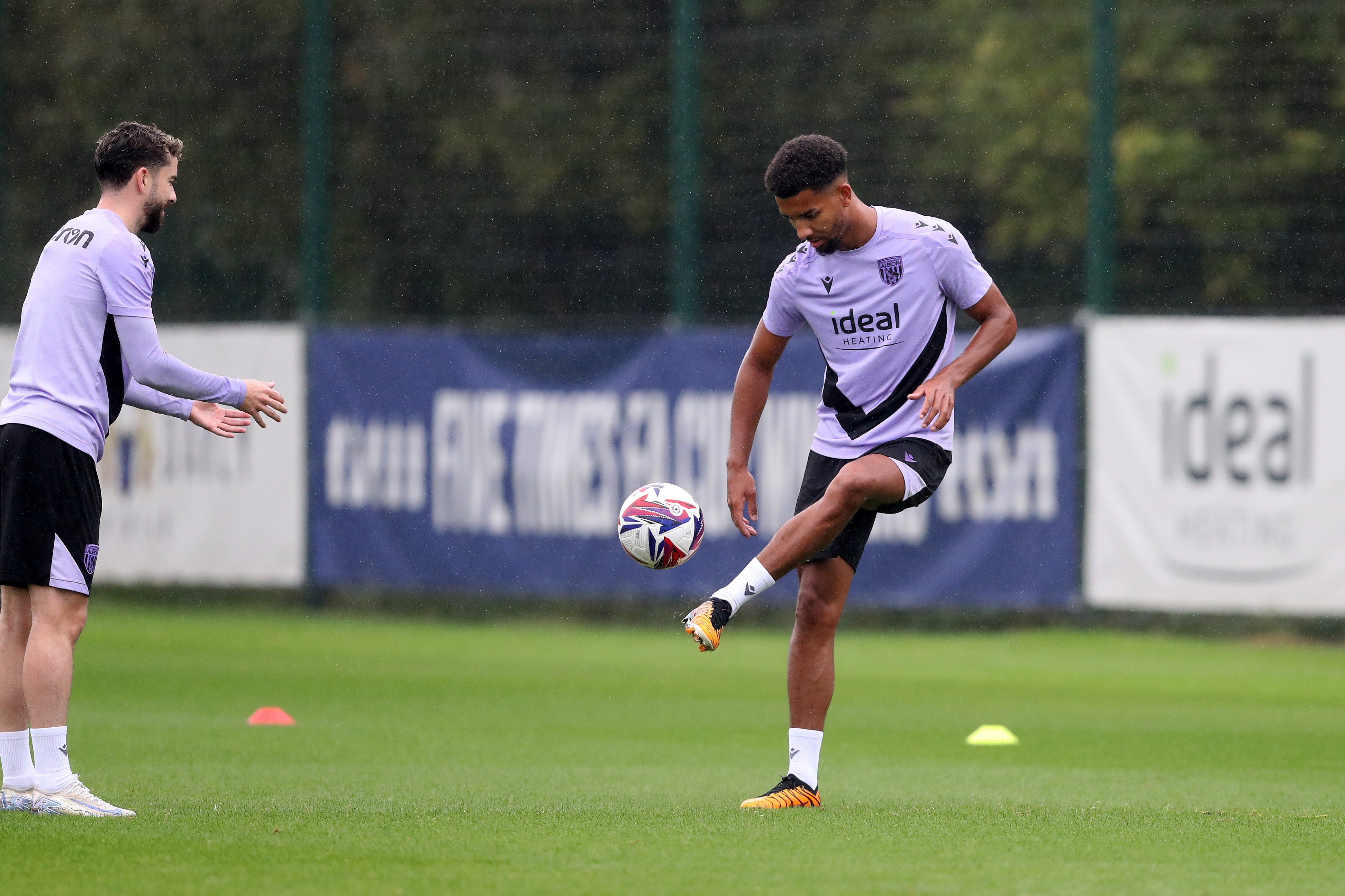 Mason Holgate passes a ball back to Mikey Johnston out on the training pitch 