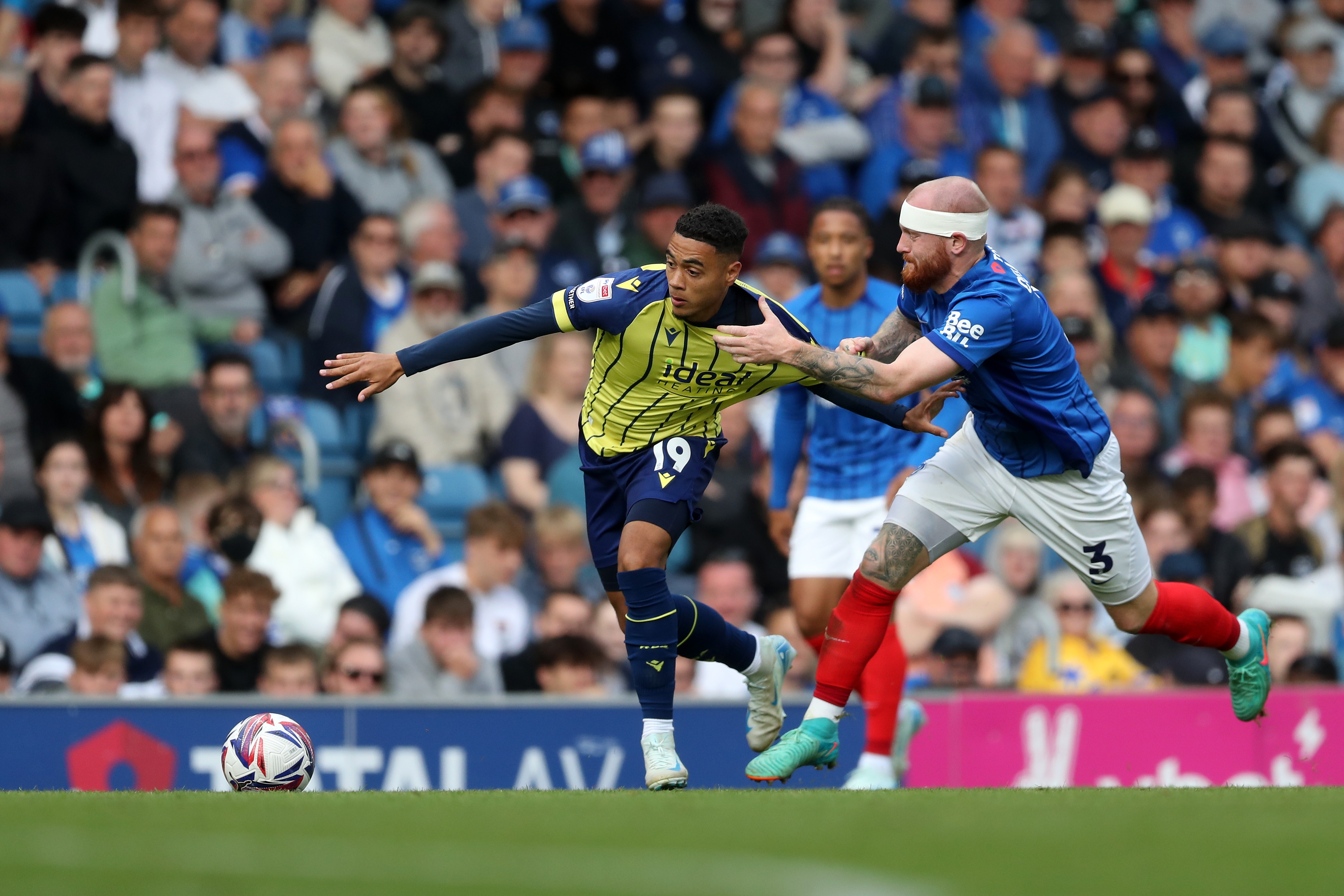 Albion in action against Portsmouth at Fratton Park, in yellow and blue away colours.