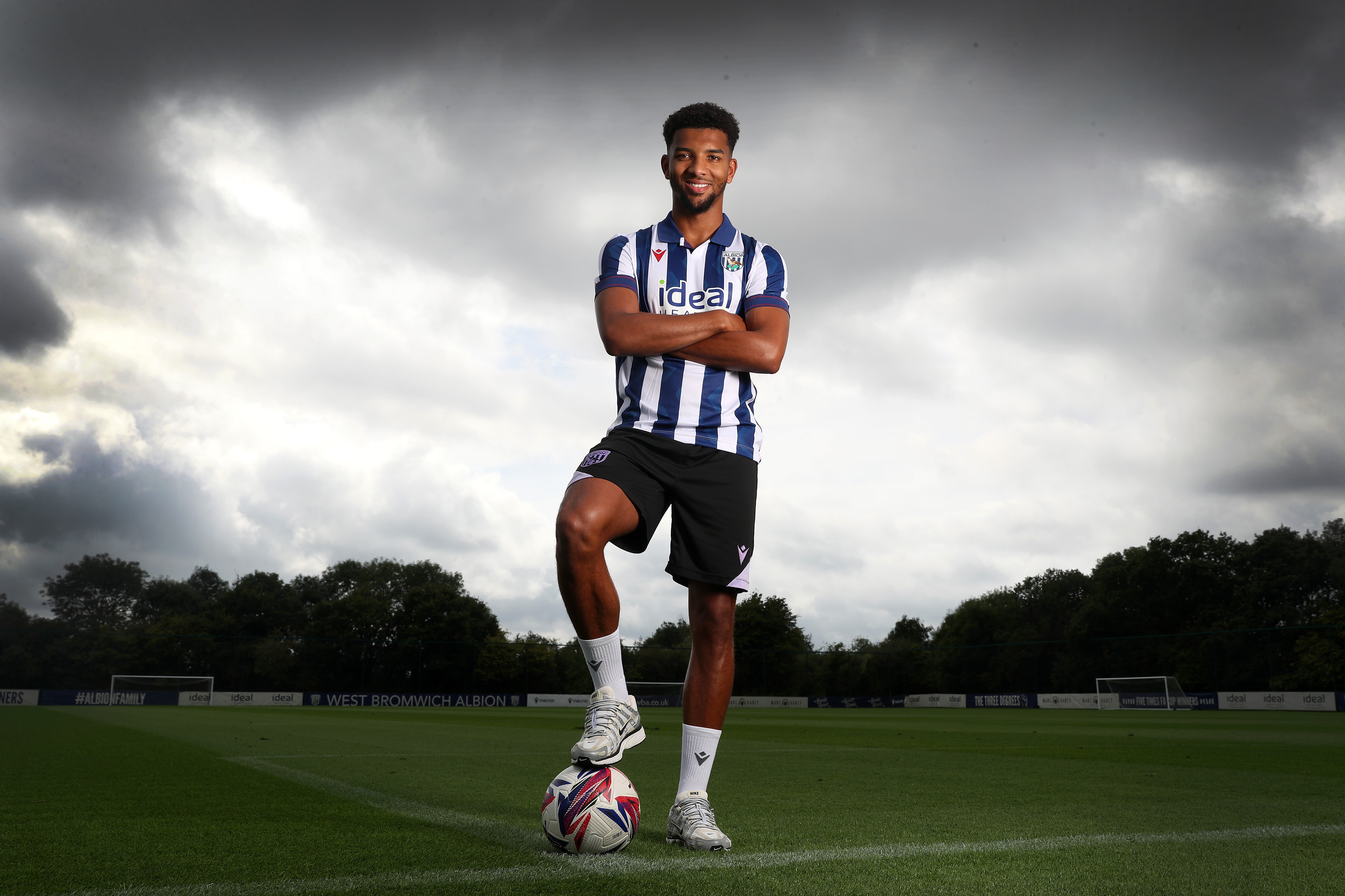 Mason Holgate stood on a training pitch in the home shirt with one foot on the ball and his arms crossed