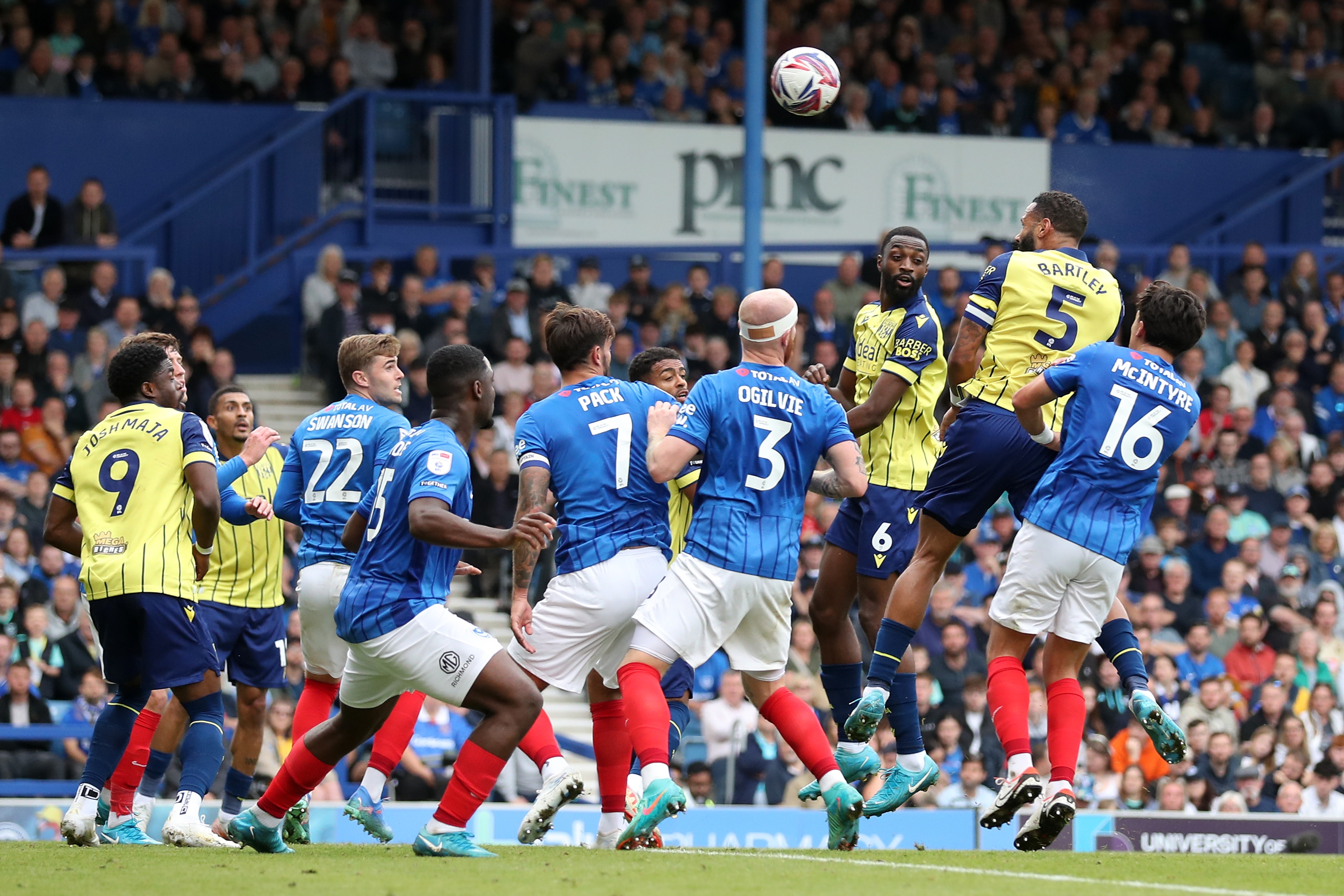 Albion in action against Portsmouth at Fratton Park, in yellow and blue away colours.