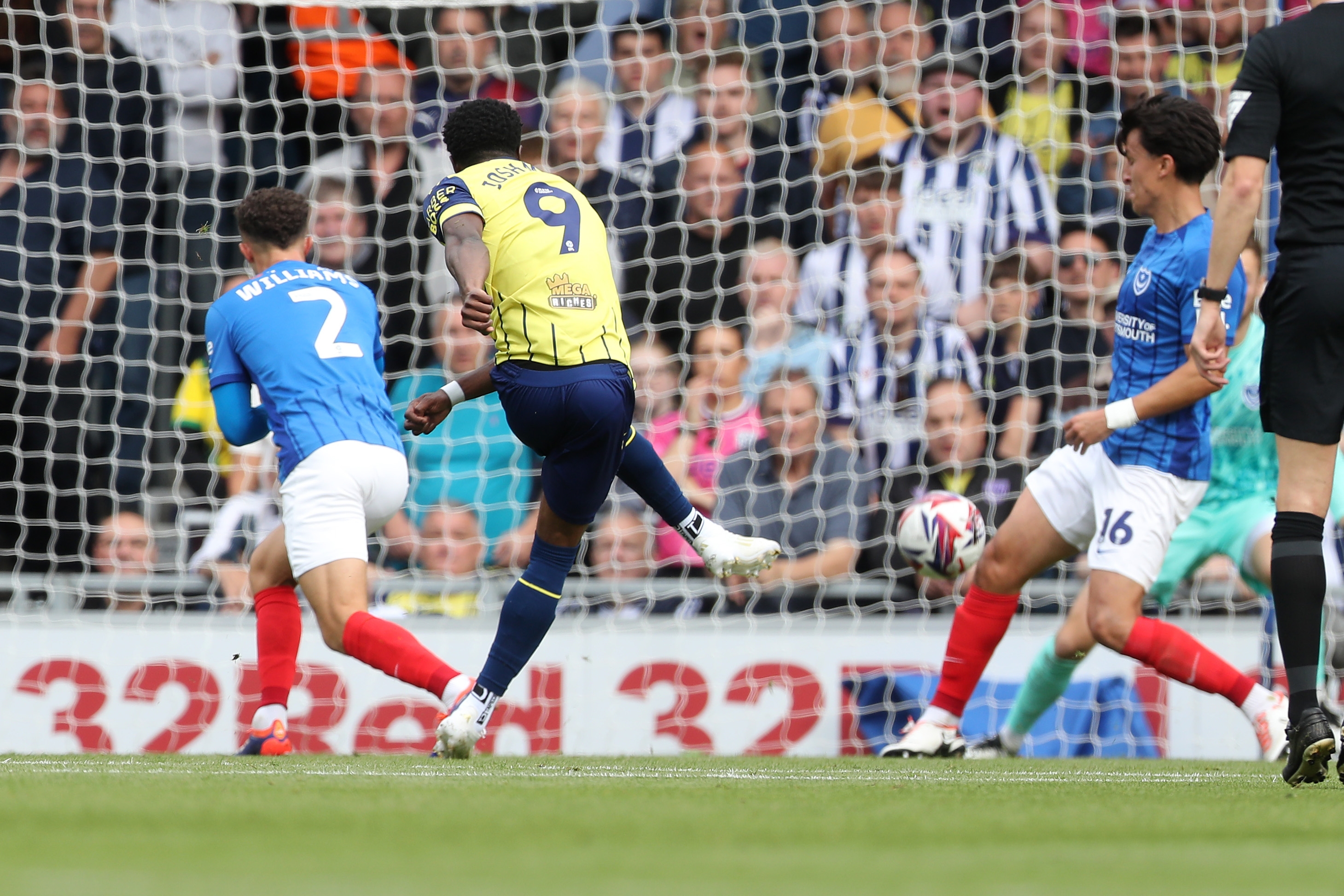 Albion in action against Portsmouth at Fratton Park, in yellow and blue away colours.