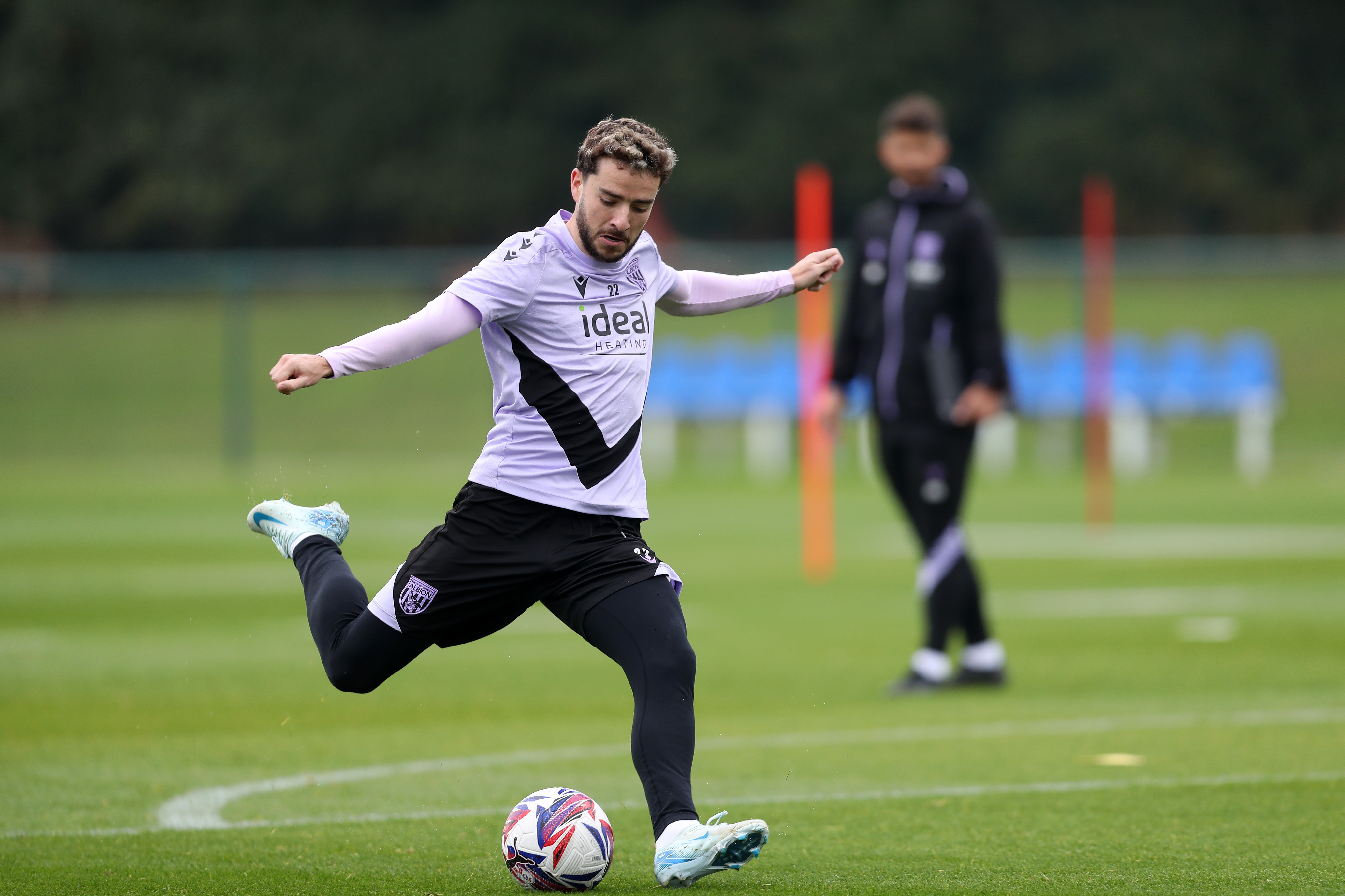 Mikey Johnston strikes at goal during a training session 