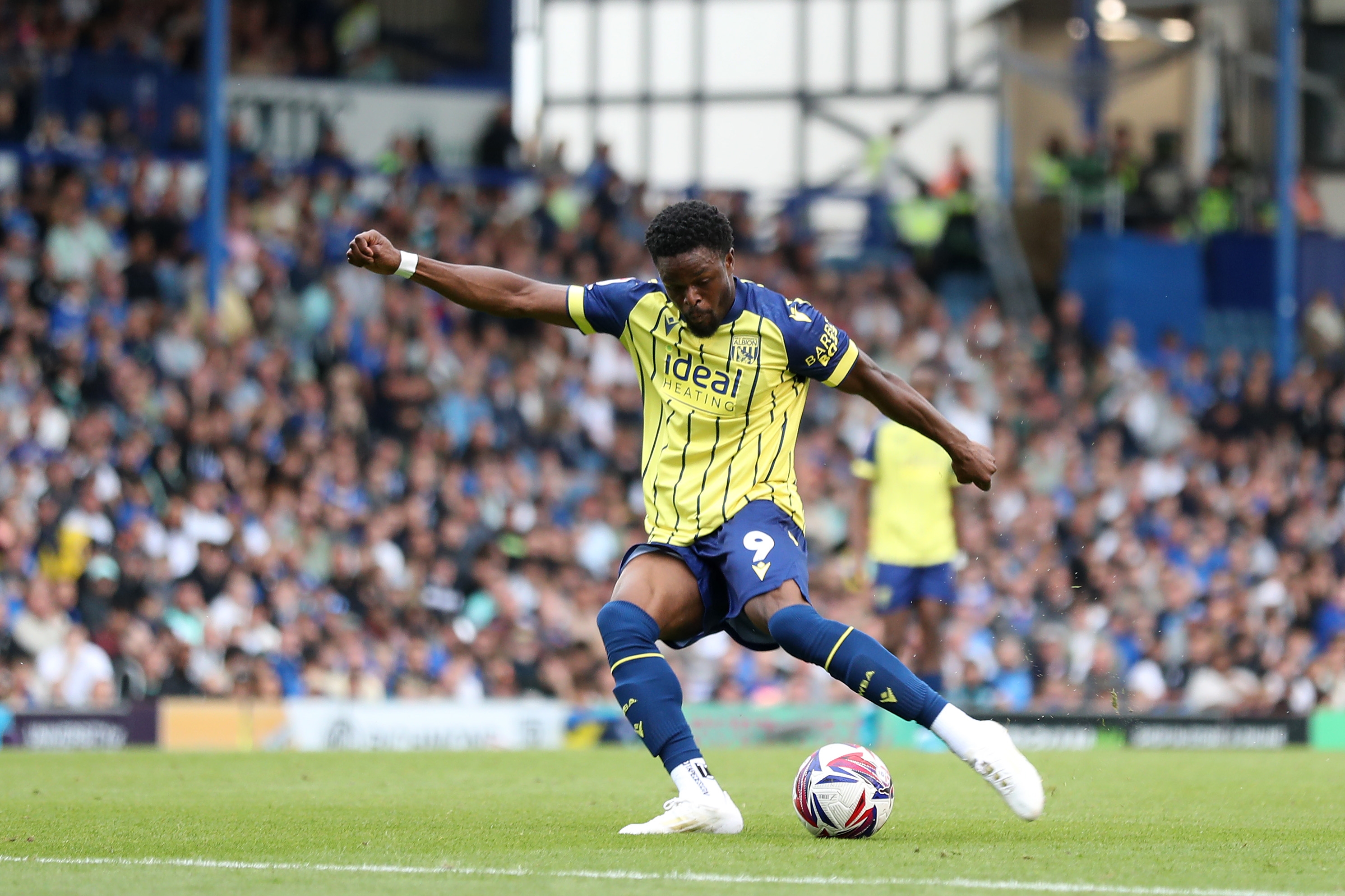 Albion in action against Portsmouth at Fratton Park, in yellow and blue away colours.