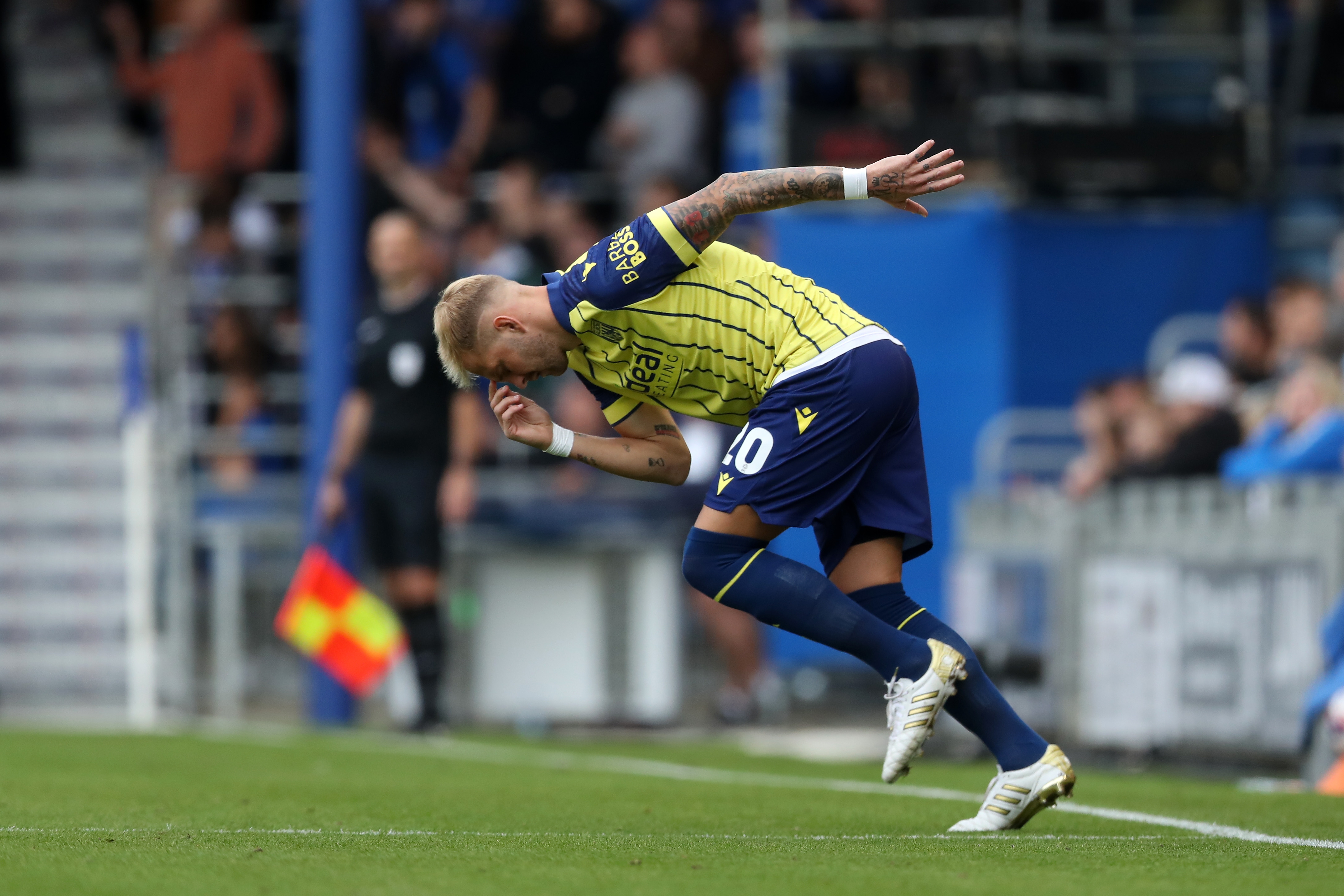 Albion in action against Portsmouth at Fratton Park, in yellow and blue away colours.