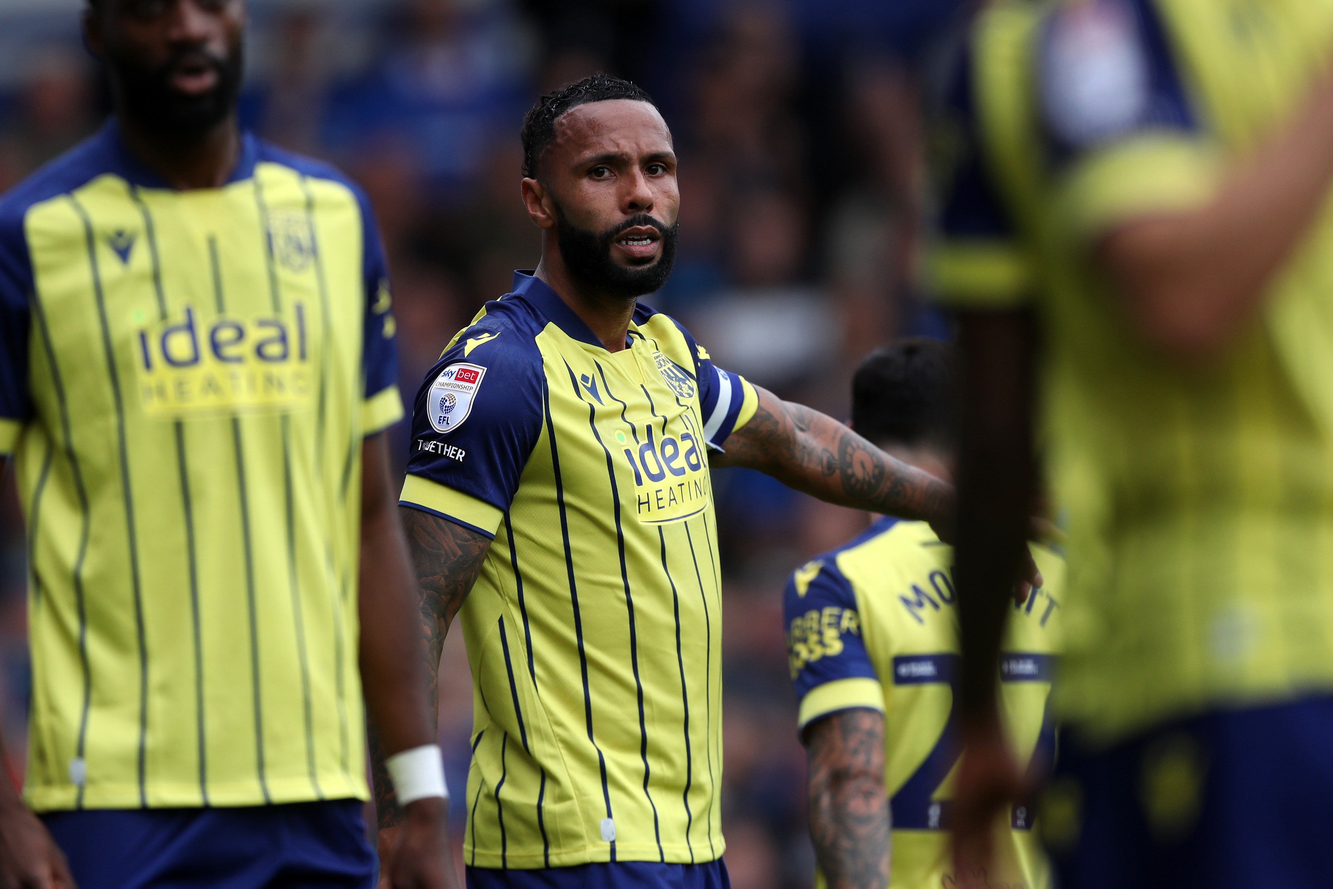 Albion in action against Portsmouth at Fratton Park, in yellow and blue away colours.