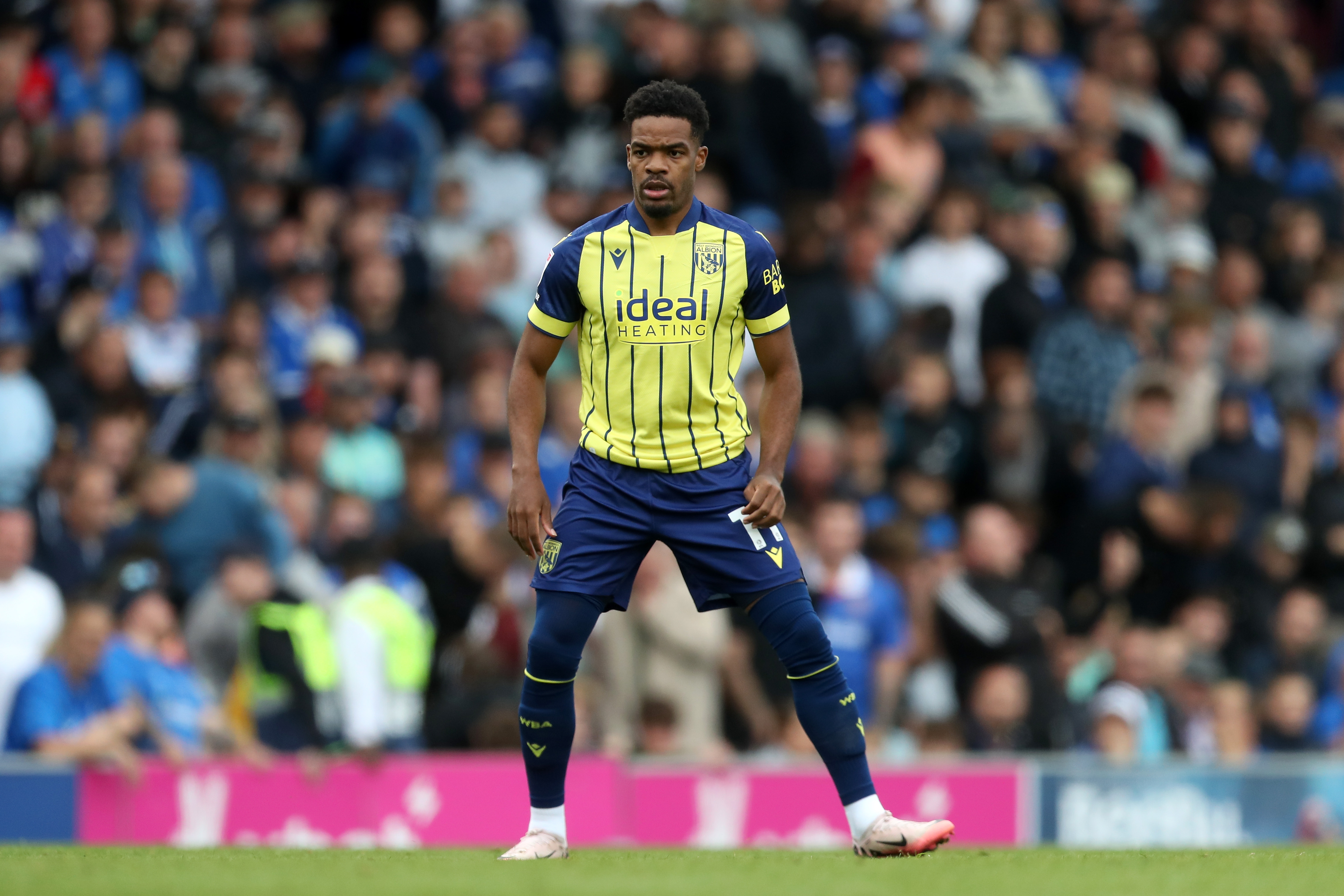 Albion in action against Portsmouth at Fratton Park, in yellow and blue away colours.