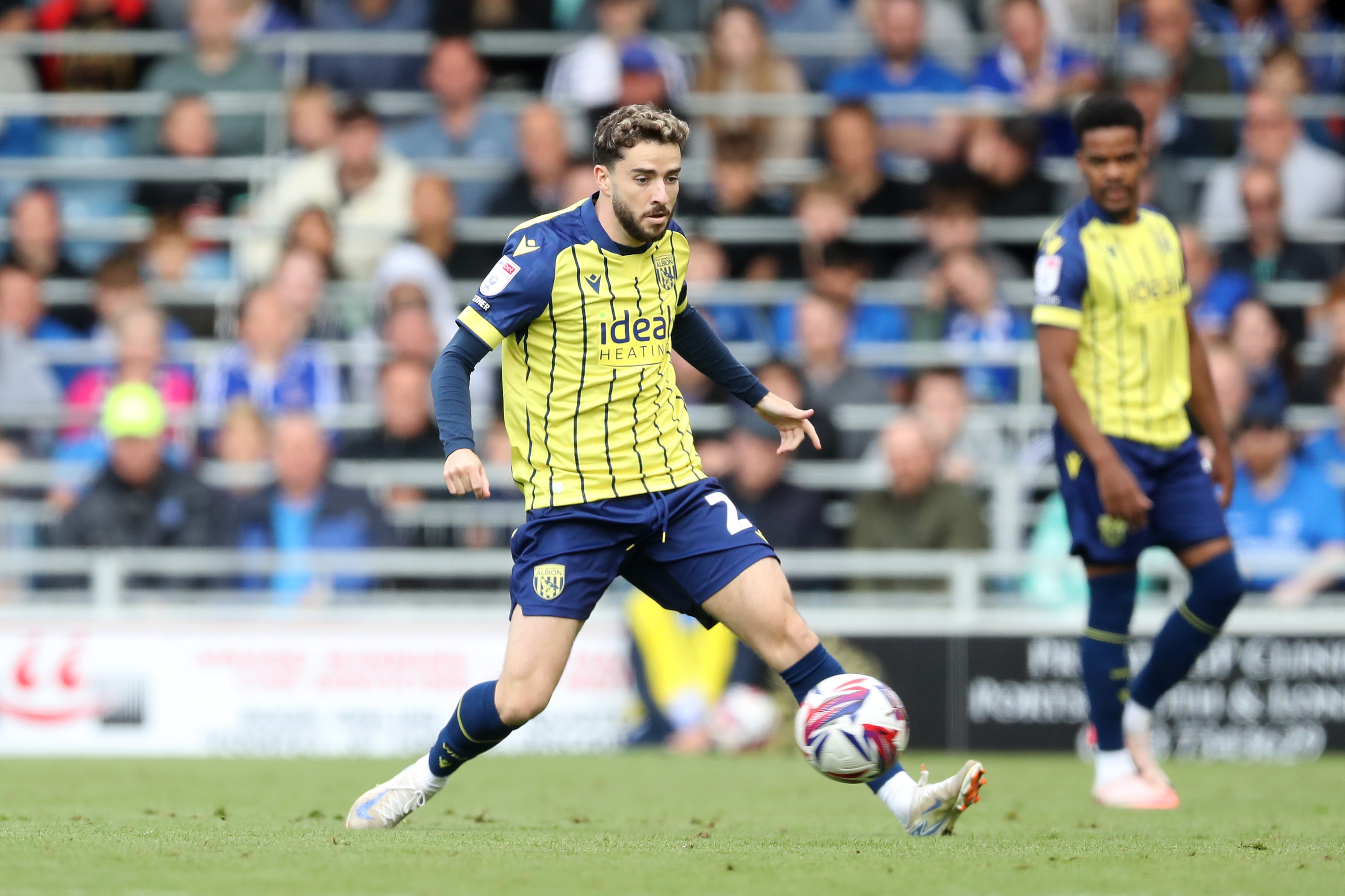 Albion in action against Portsmouth at Fratton Park, in yellow and blue away colours.