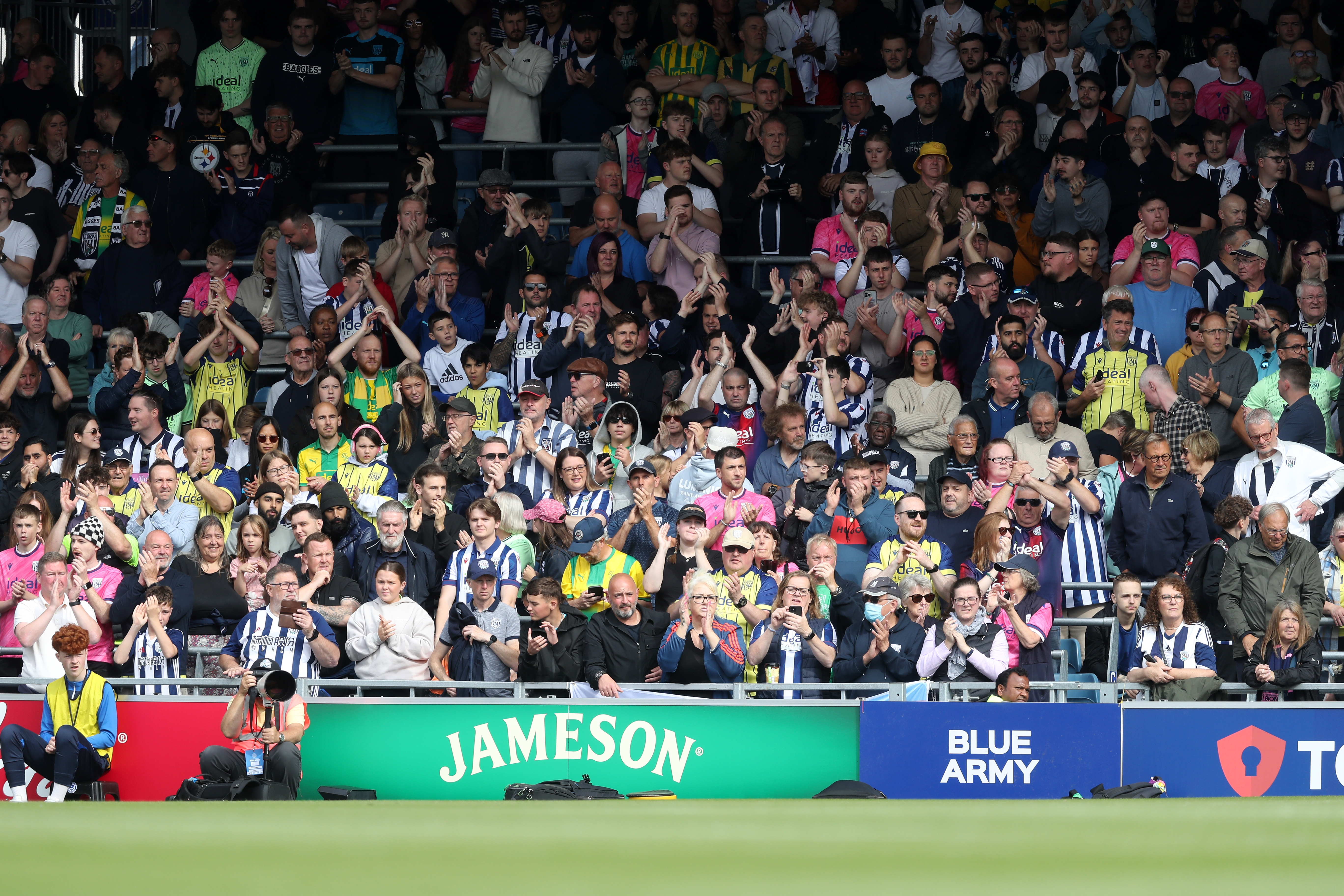 Albion in action against Portsmouth at Fratton Park, in yellow and blue away colours.