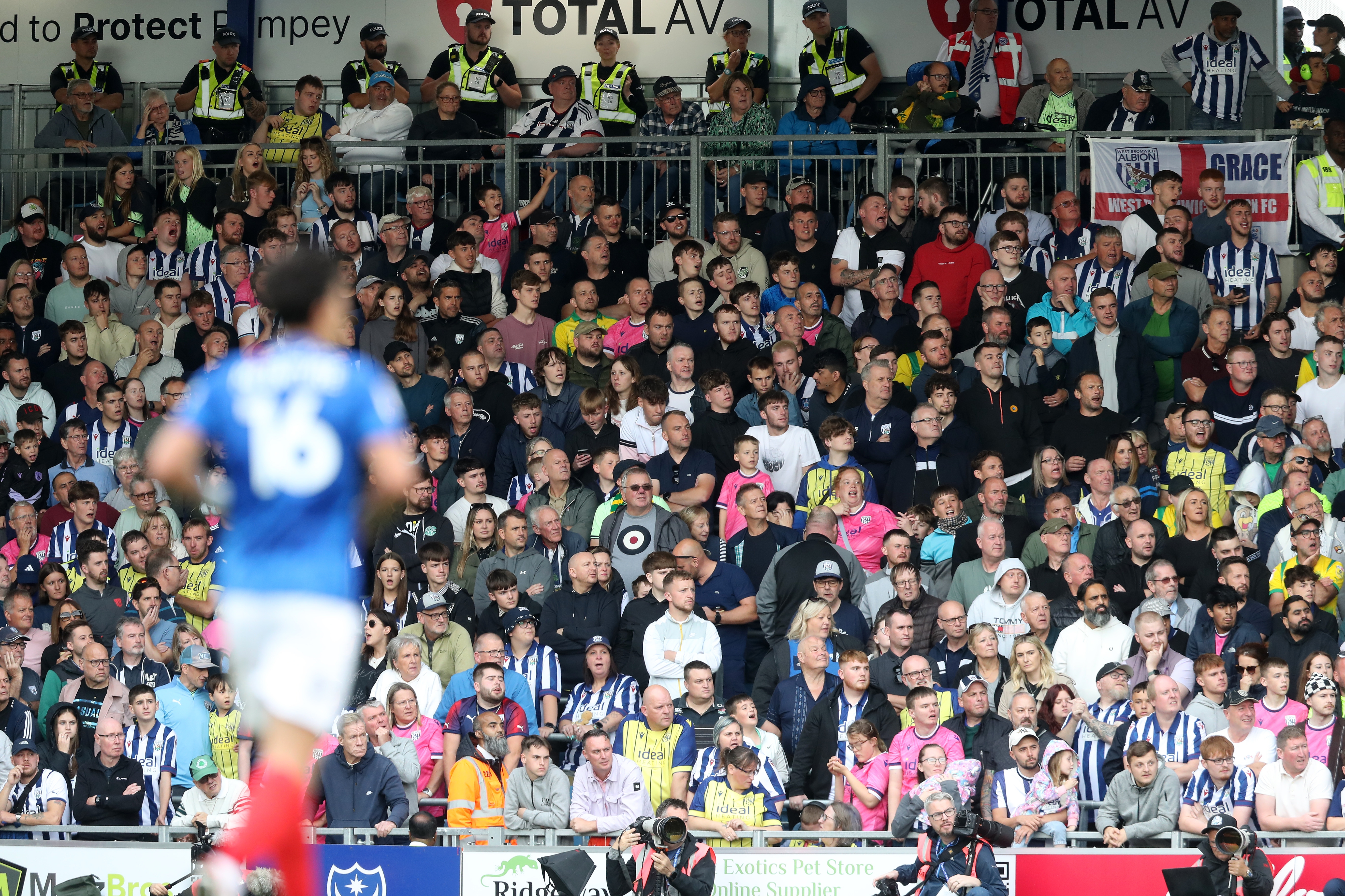 Albion in action against Portsmouth at Fratton Park, in yellow and blue away colours.