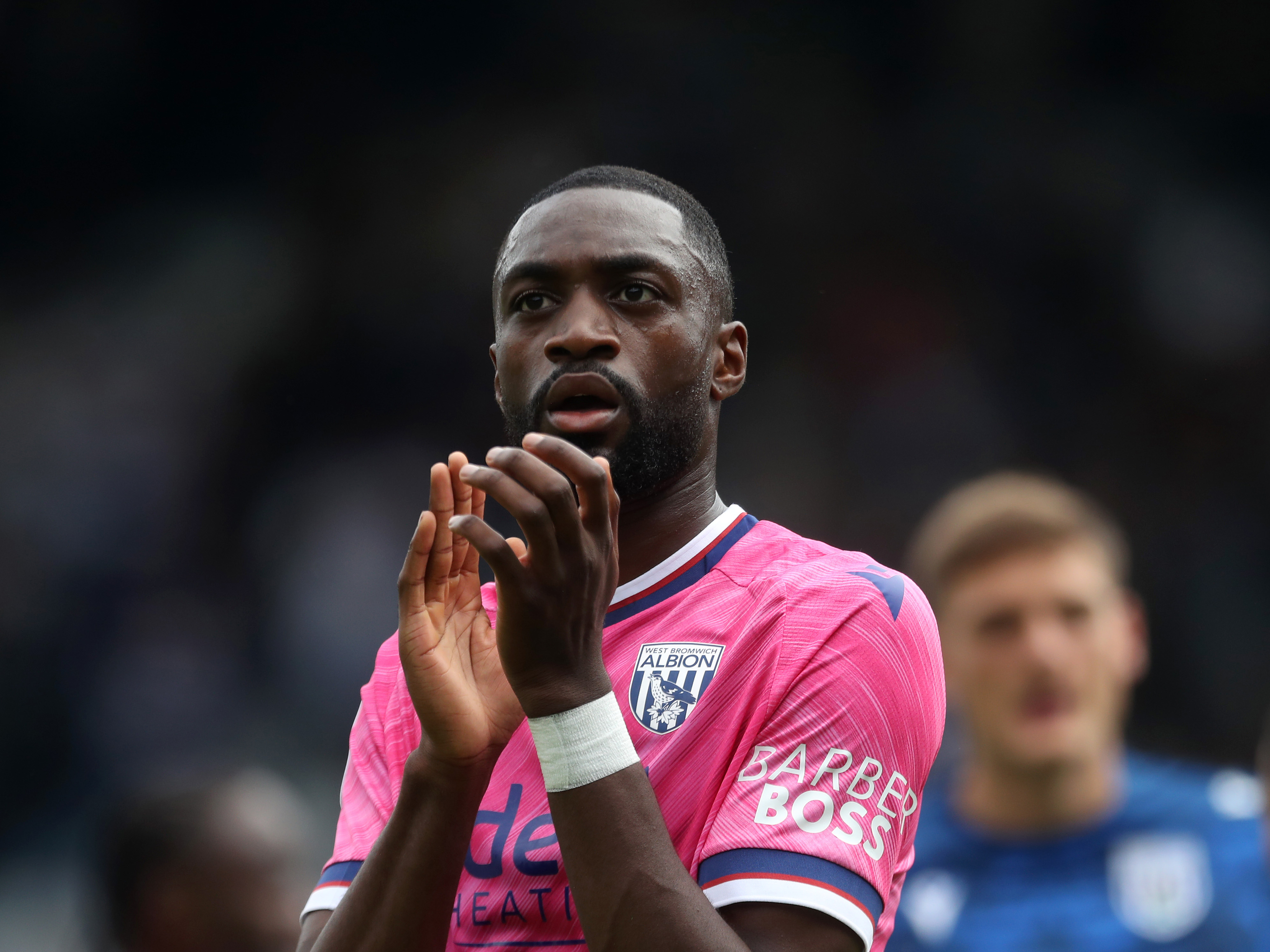 A photo of Semi Ajayi applauding Albion fans in the 2024/25 pink away kit