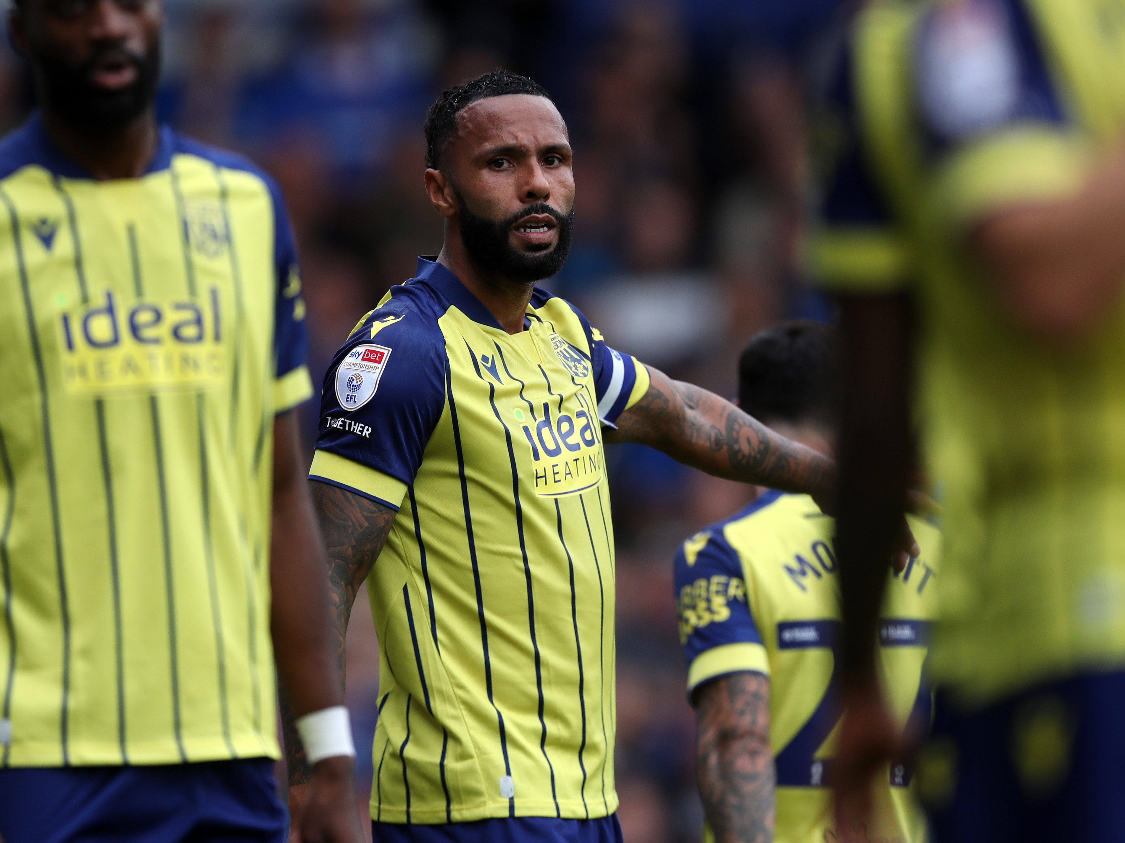 A photo of Kyle Bartley in the yellow and blue 2024/25 away kit in action against Portsmouth