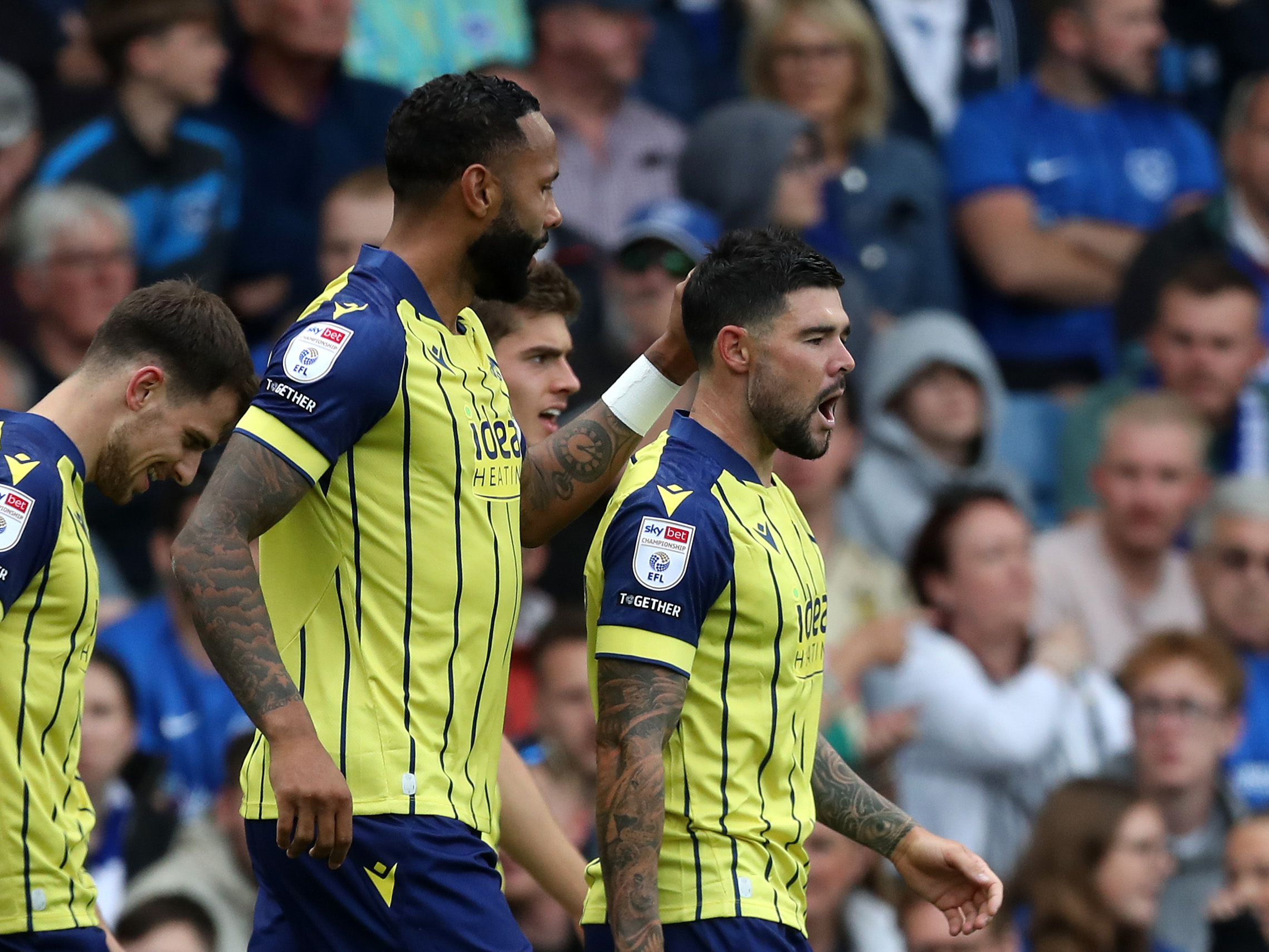 A photo of Alex Mowatt and Kyle Bartley in the yellow and blue 2024/25 away kit celebrating a goal against Portsmouth