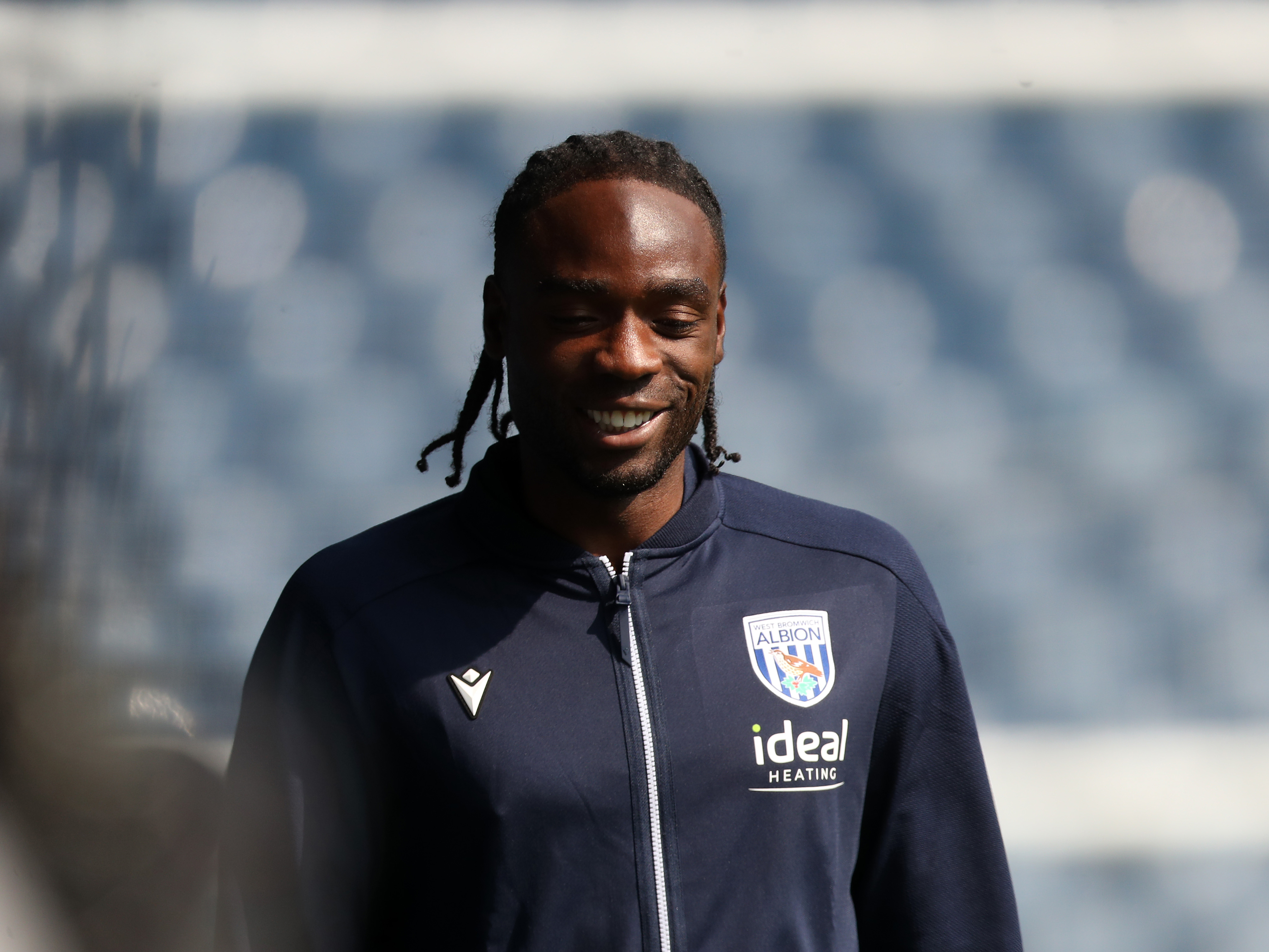 Devante Cole smiling while wearing a club tracksuit 