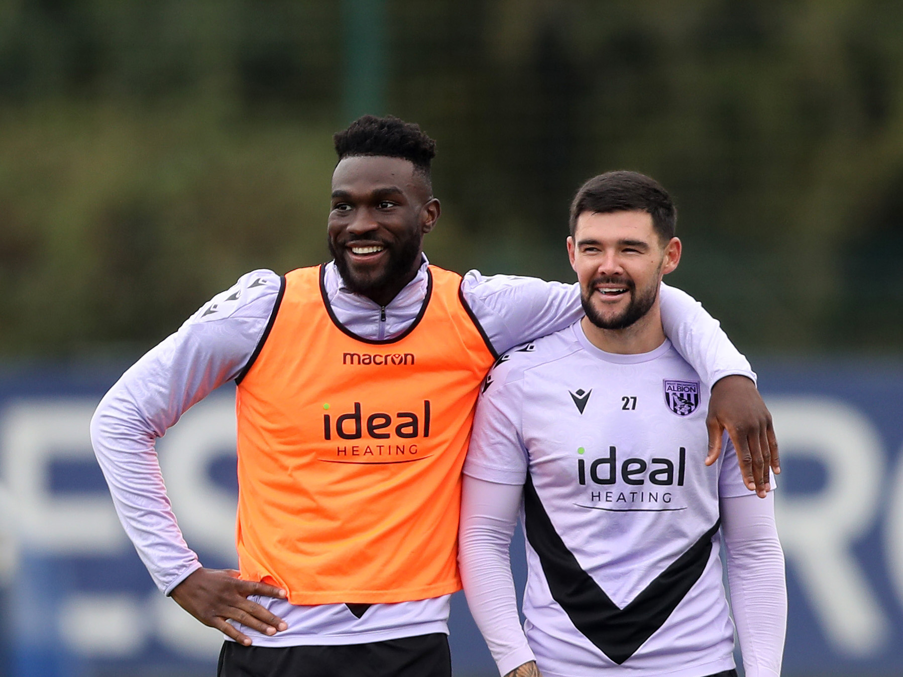 Daryl Dike and Alex Mowatt smiling during a training session with Dike putting his arm around Mowatt