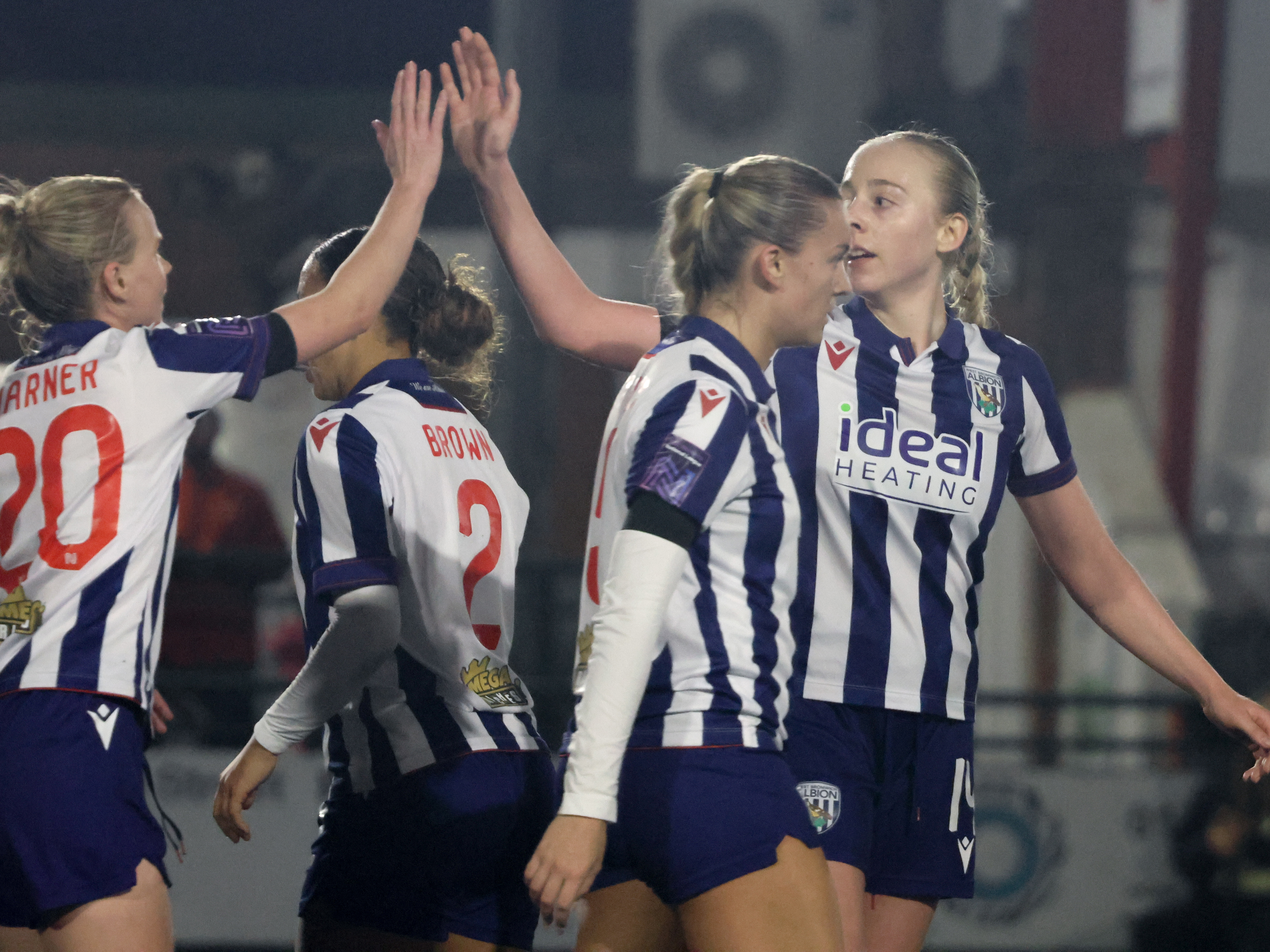 An image of Ellie May celebrating a goal with her teammates