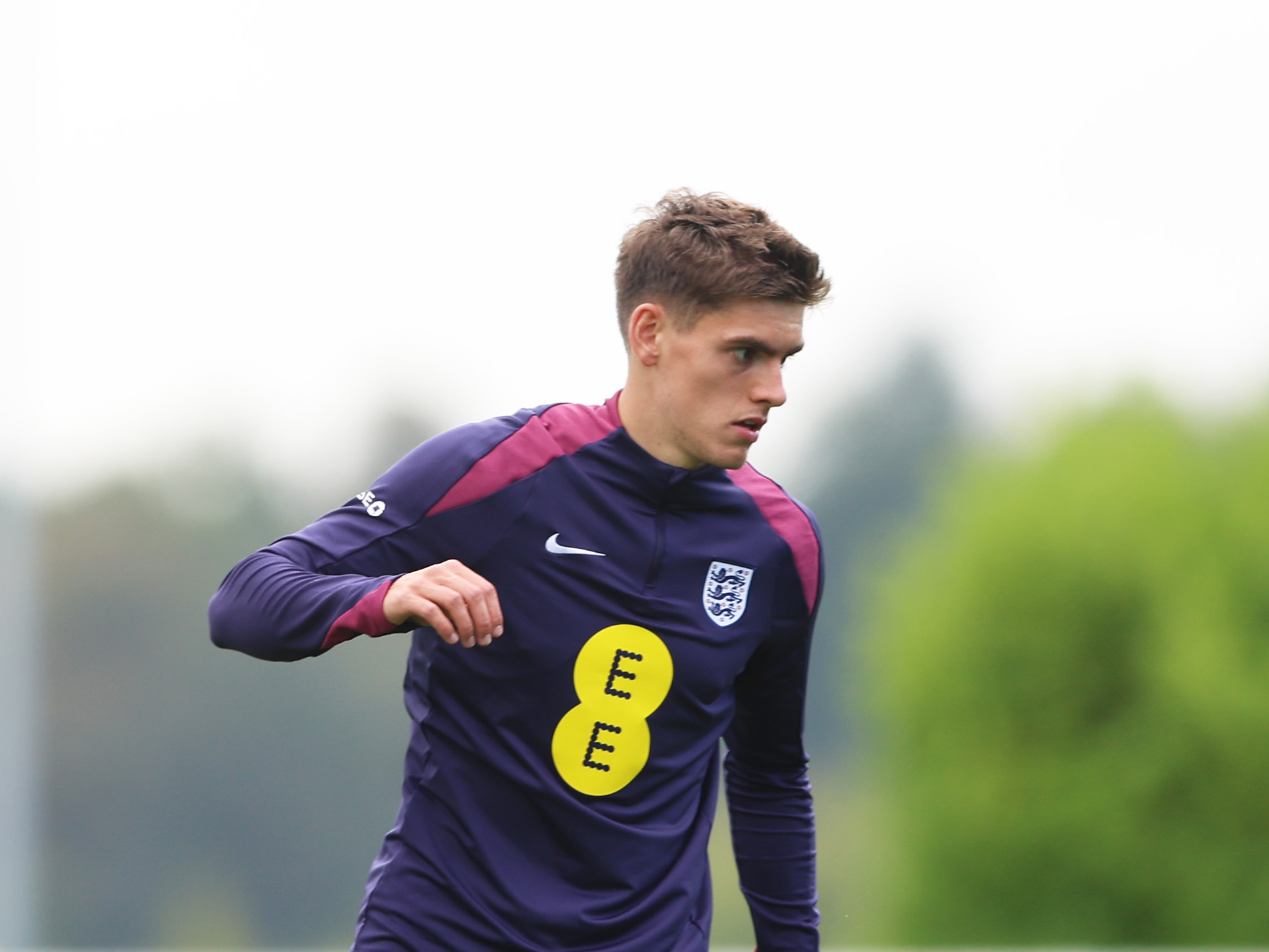 Tom Fellows in England training kit in the middle of a training session 