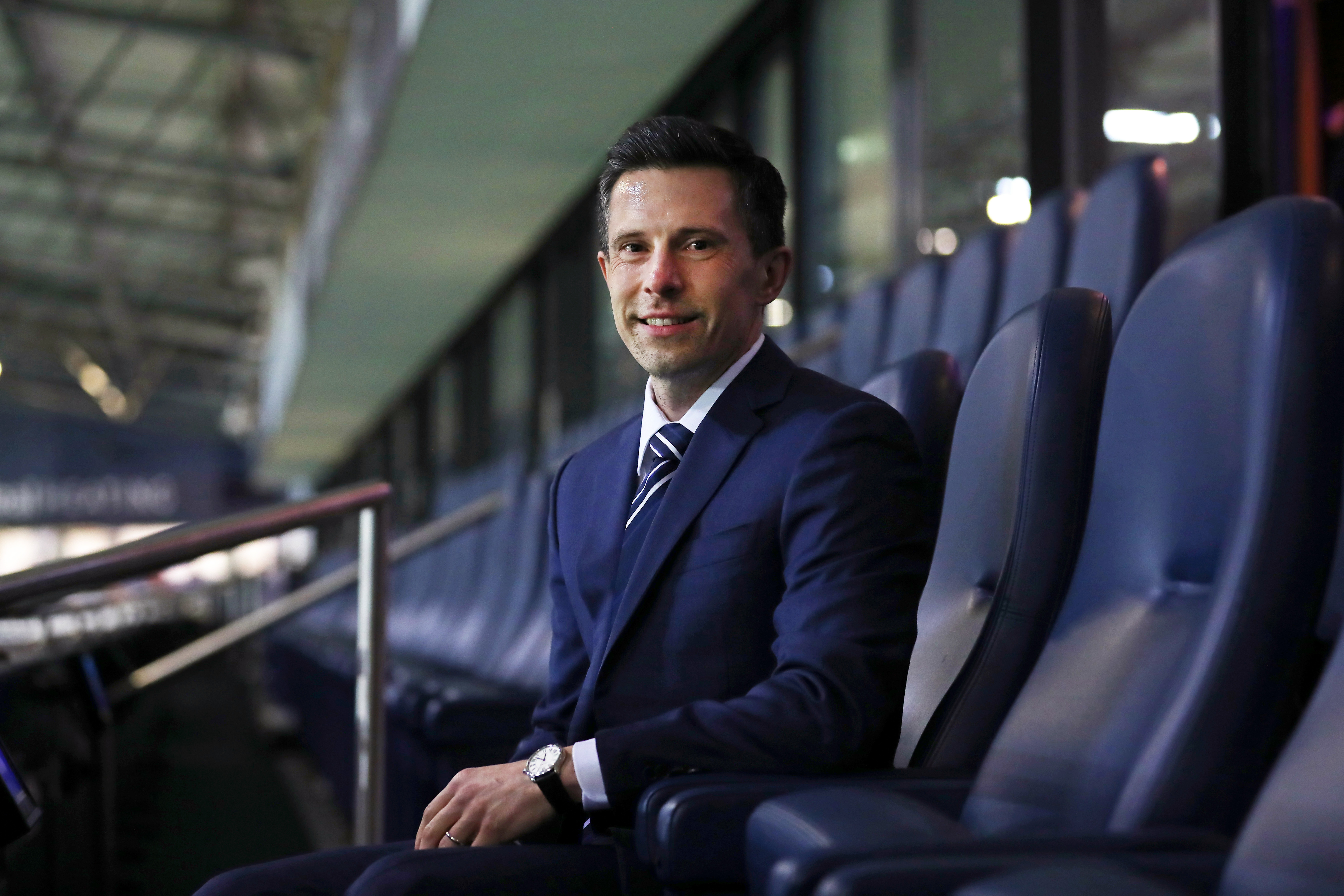 Andrew Nestor smiling at the camera while sat in a suite at The Hawthorns 