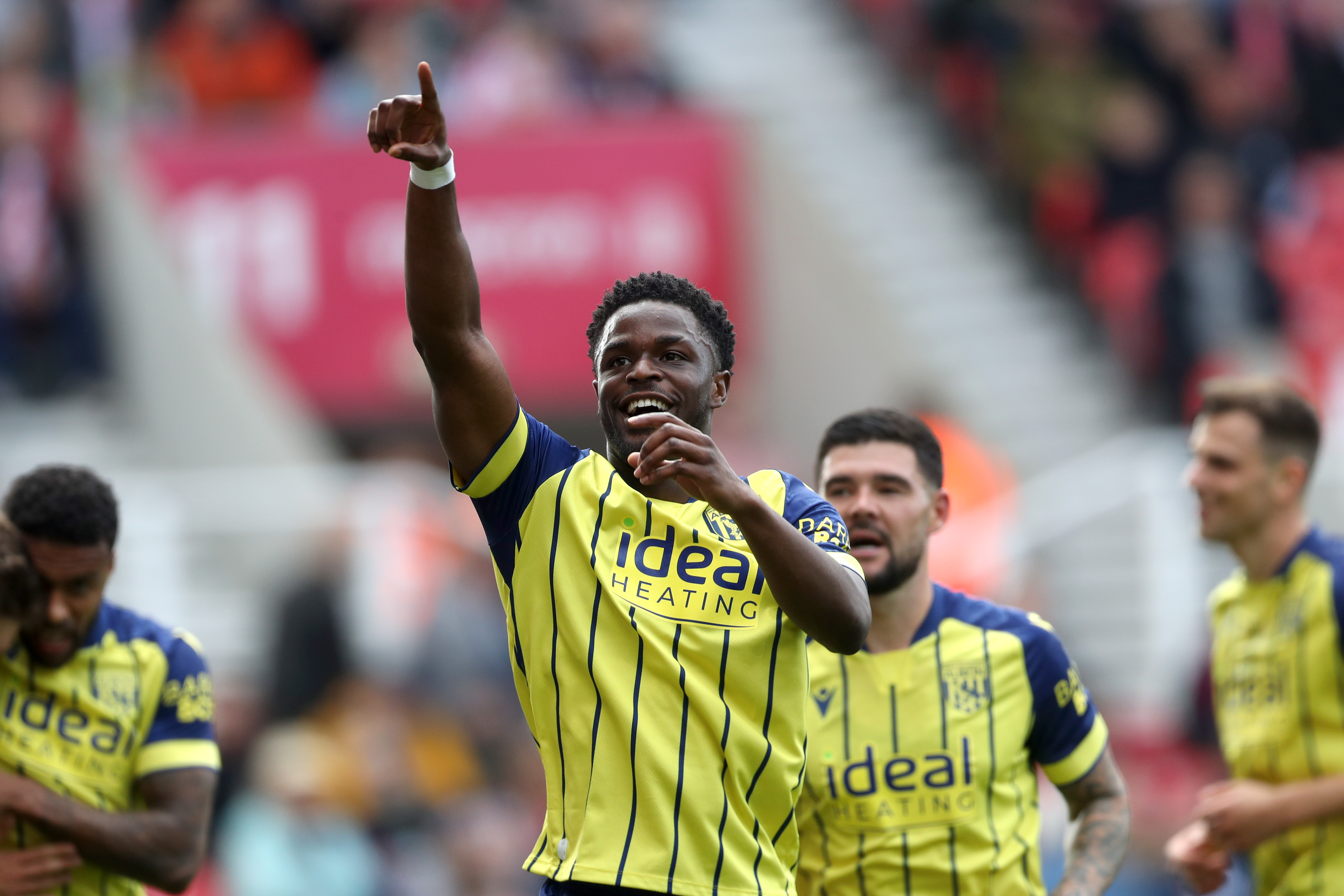 Josh Maja celebrates scoring at Stoke while wearing the yellow away kit 