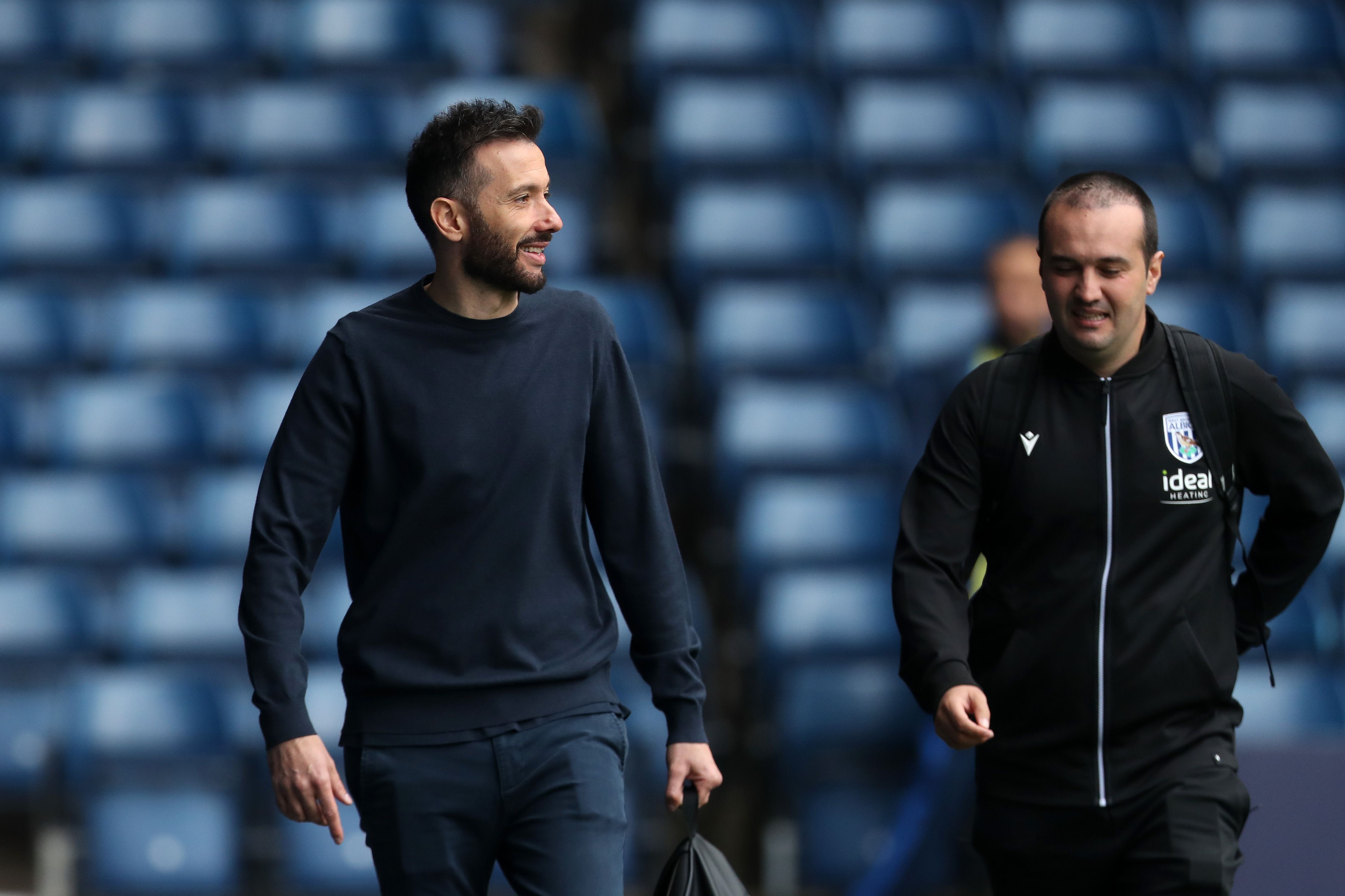 Carlos Corberán looking to his left while arriving at The Hawthorns for a game 