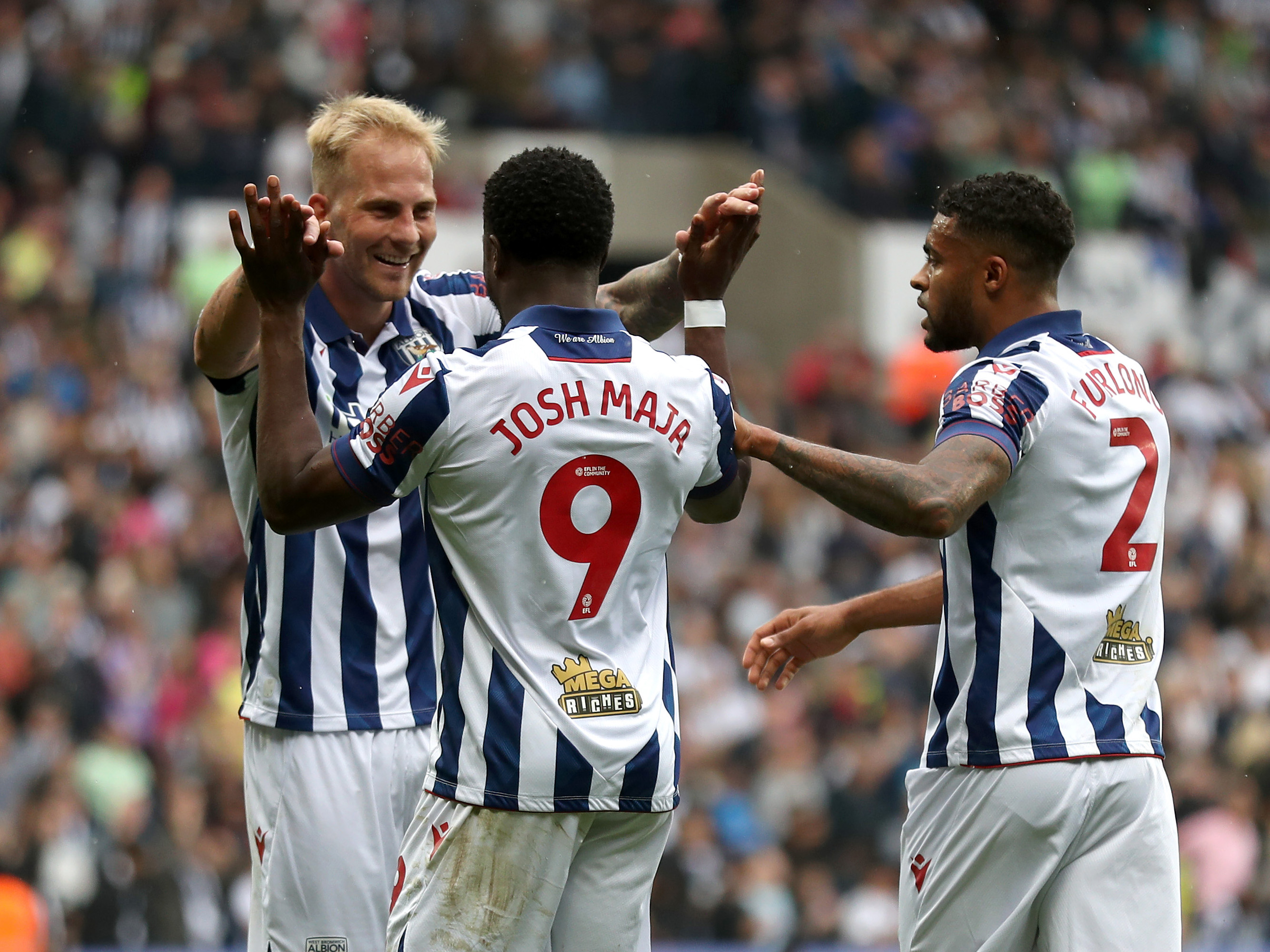 Uroš Račić celebrates with Josh Maja and Darnell Furlong after an Albion goal