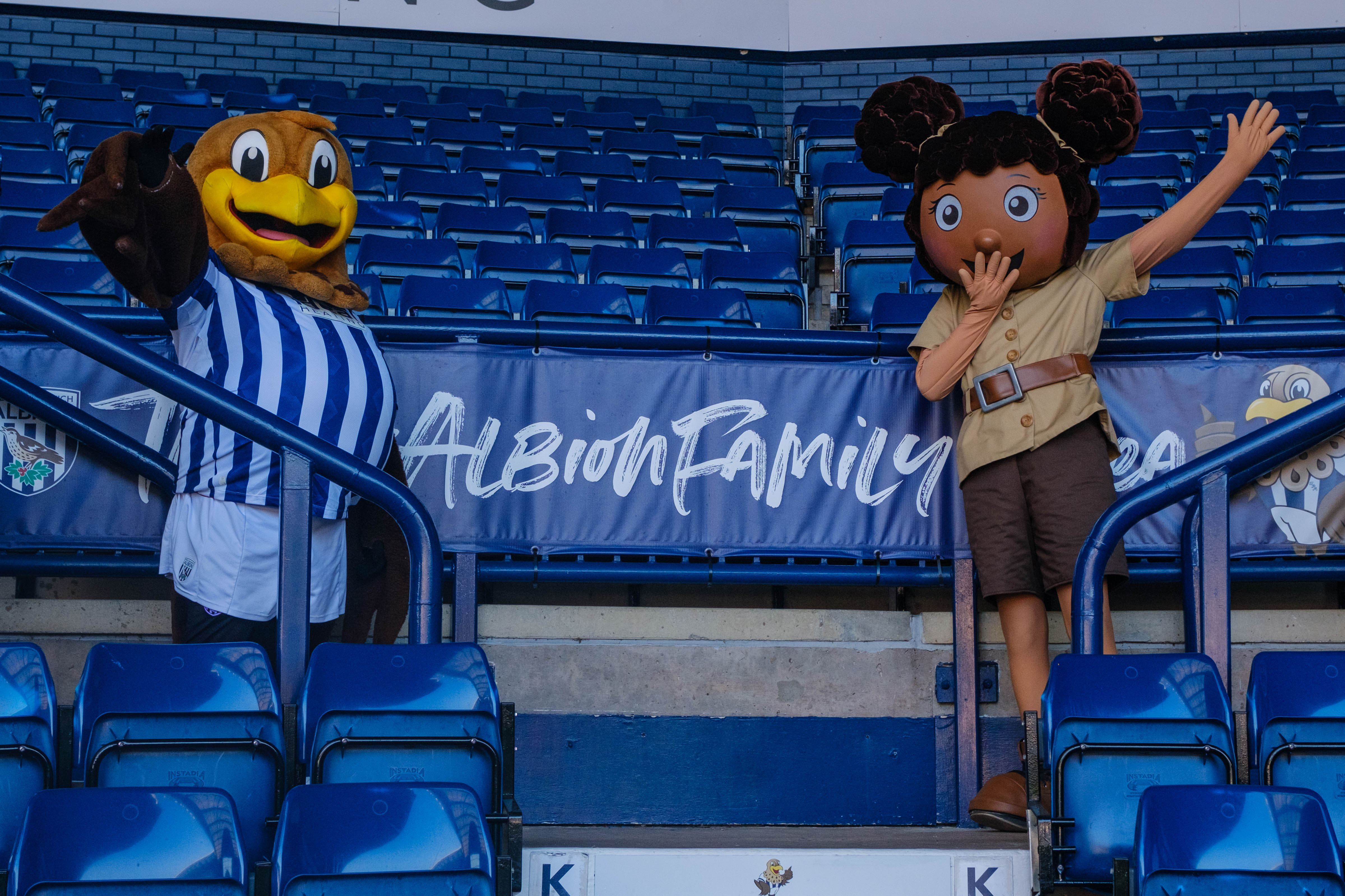 Baggie Bird & Eliza standing next to the Family Stand #AlbionFamily banner.