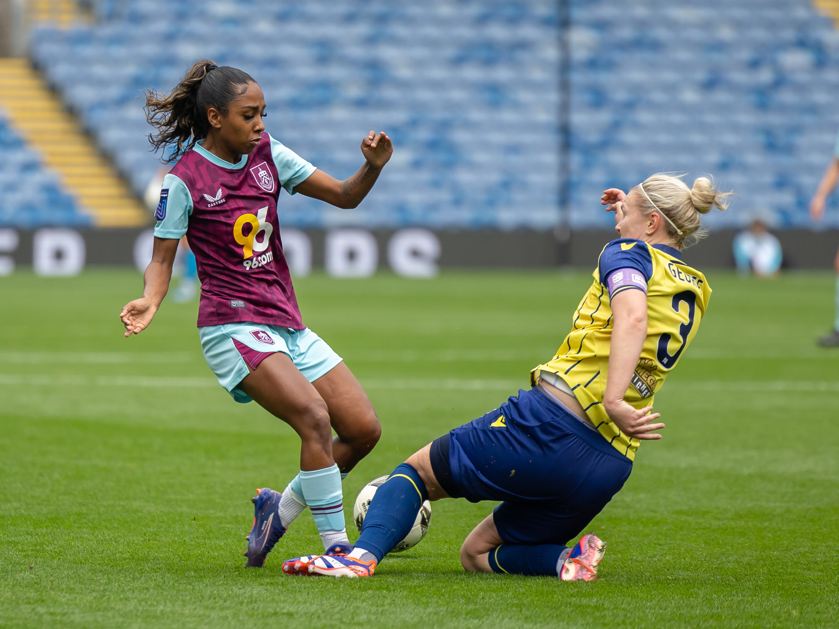 An image of Hannah George tackling a Burnley player